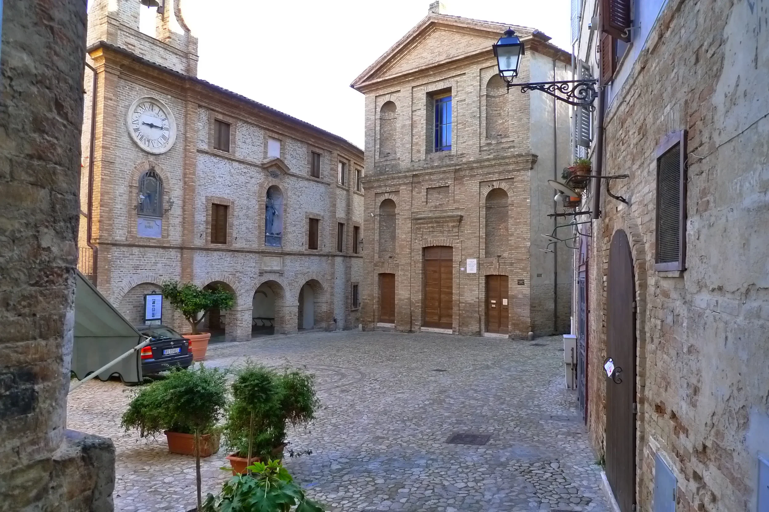 Piazza Peretti in Grottammare Alta, with its clock tower, arcades and the church of San Giovanni Battista