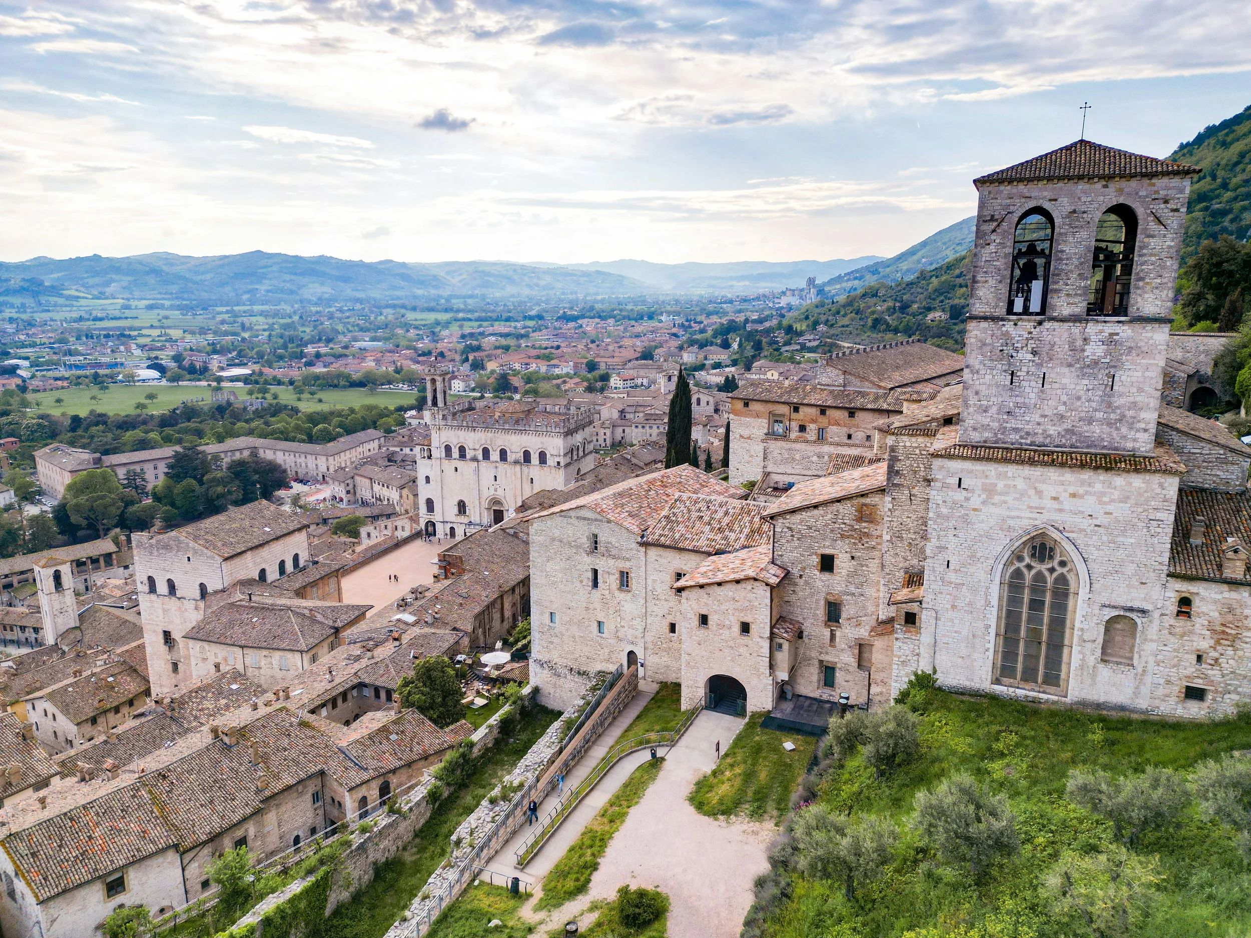 Gubbio rooftops, the cathedral bell tower and Palazzo dei Consoli above the Umbrian valley