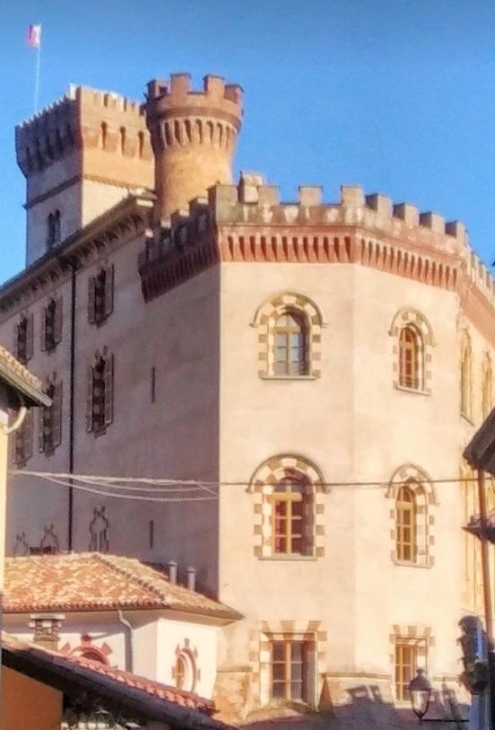 Falletti Castle in Barolo, with crenellated towers above the village rooftops