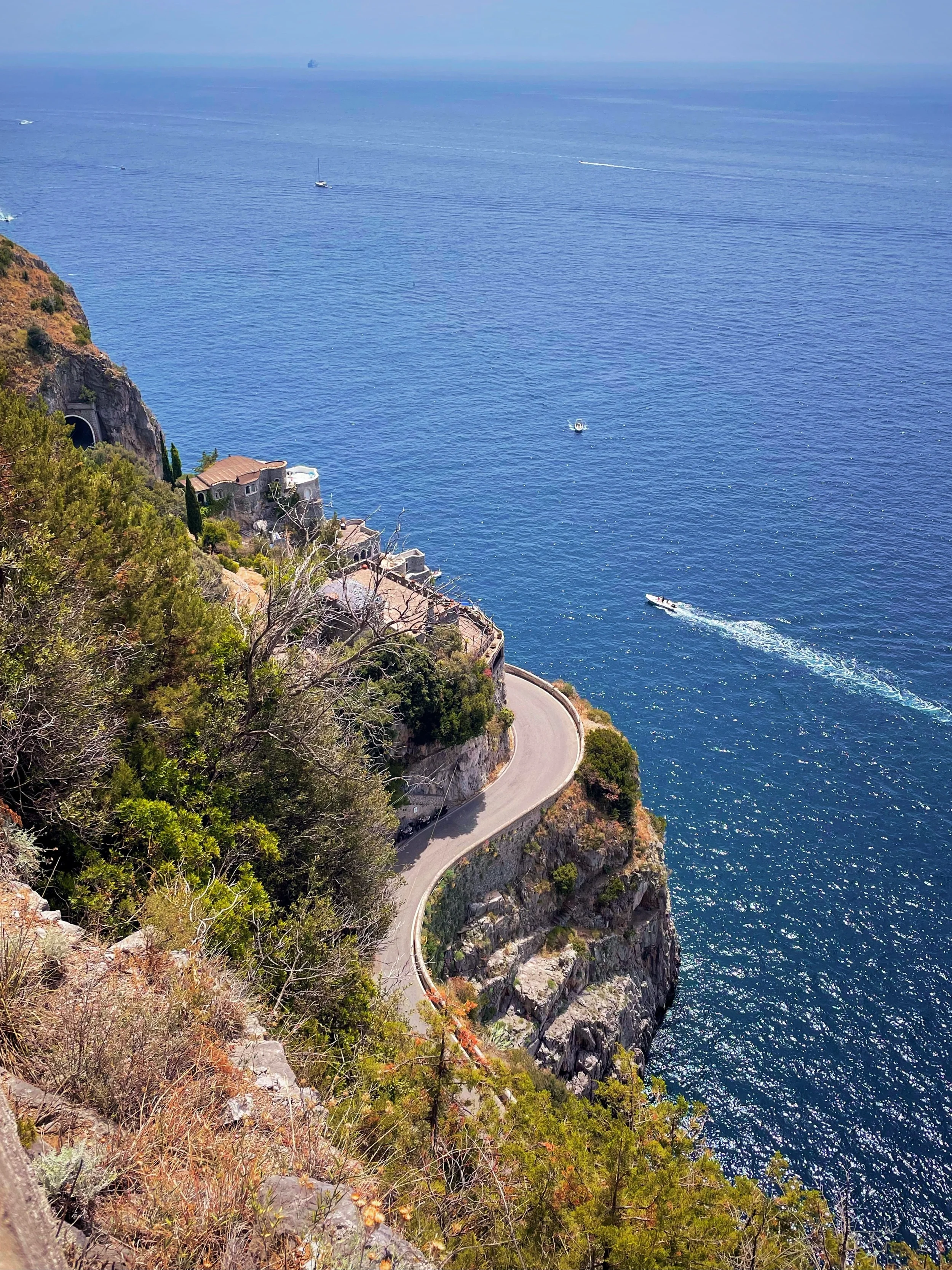 Winding coastal road above the blue Mediterranean Sea on the Amalfi Coast, Campania