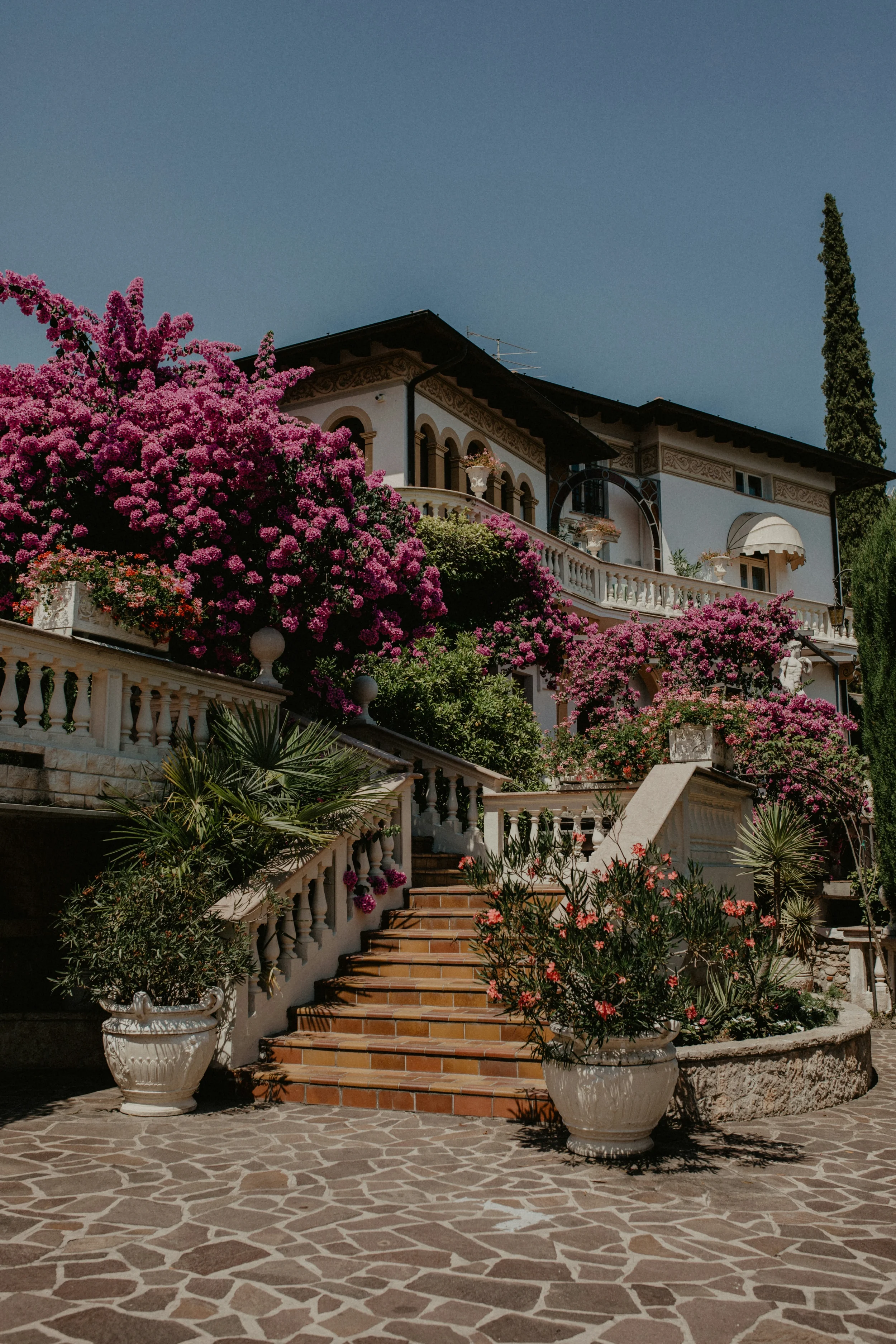 Villa with arched balconies and pink bougainvillea in Gardone Riviera on Lake Garda