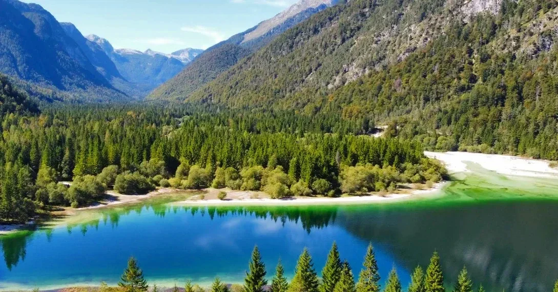 Turquoise Lago del Predil surrounded by the Julian Alps in Friuli-Venezia Giulia, Italy