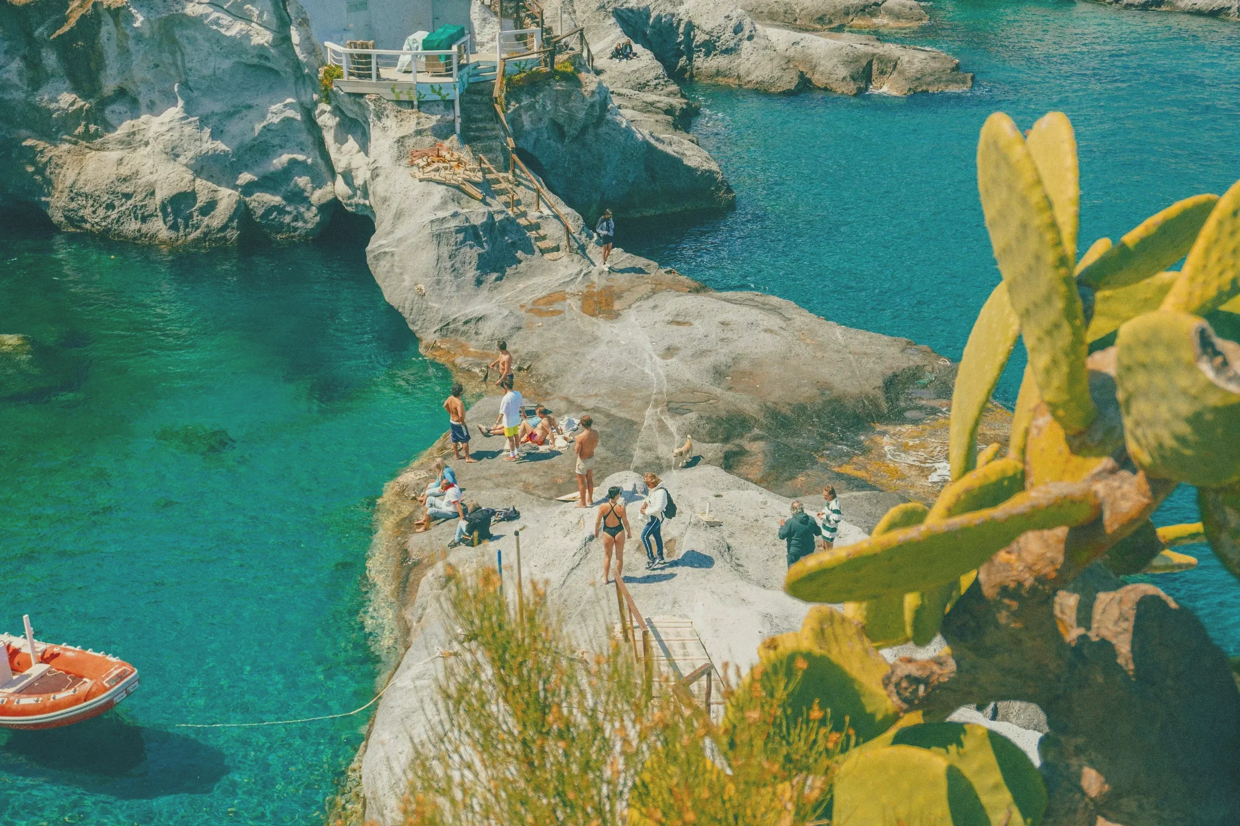 Rocky swimming cove on Ponza with crystal-clear turquoise water, volcanic cliffs and Mediterranean cactus in the Pontine Islands, Lazio