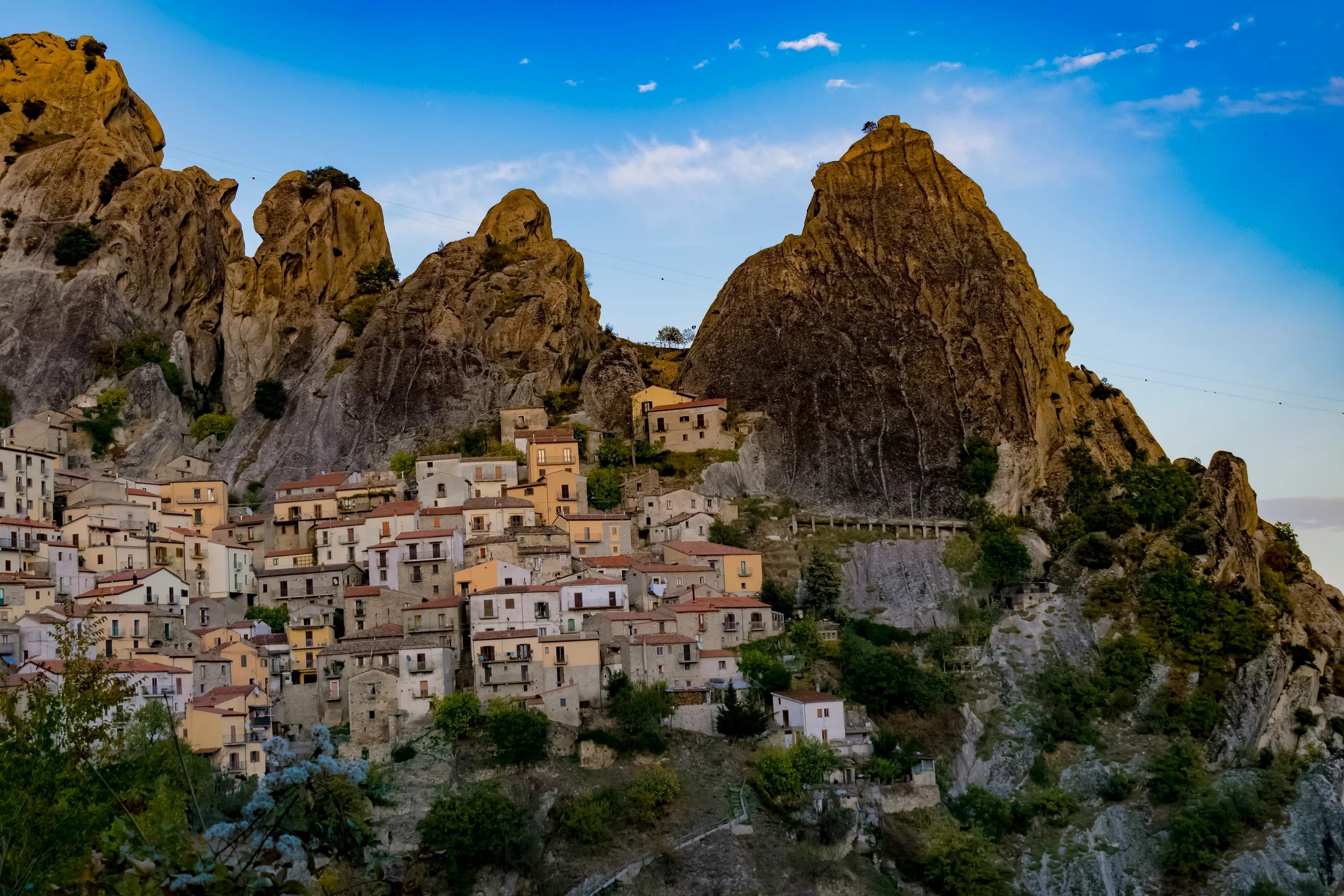Castelmezzano’s hillside houses beneath the jagged sandstone peaks of the Lucanian Dolomites, Basilicata.