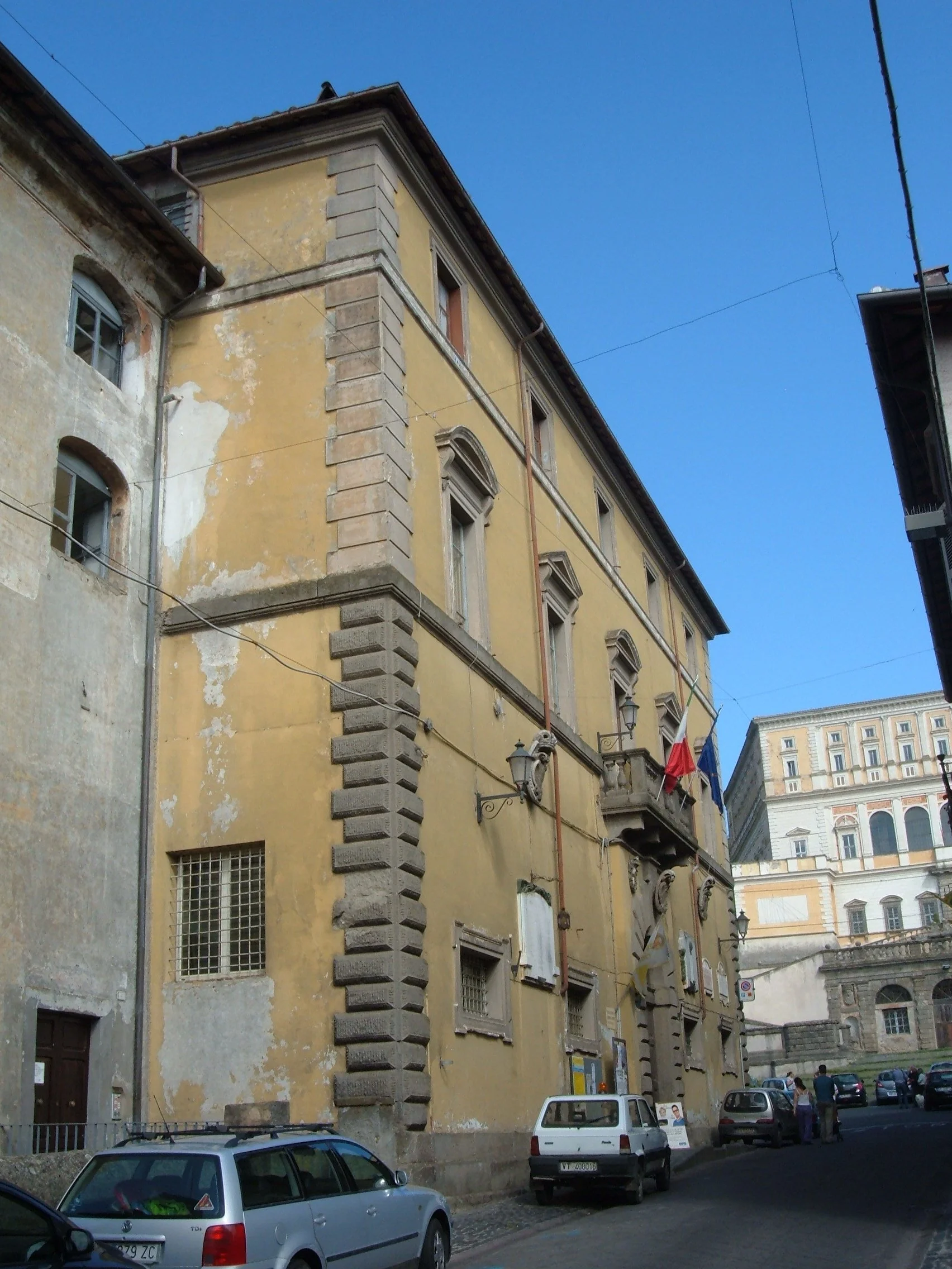 Palazzo Gherardi beside Via Filippo Nicolai in Caprarola, with Palazzo Farnese rising at the end of the street.