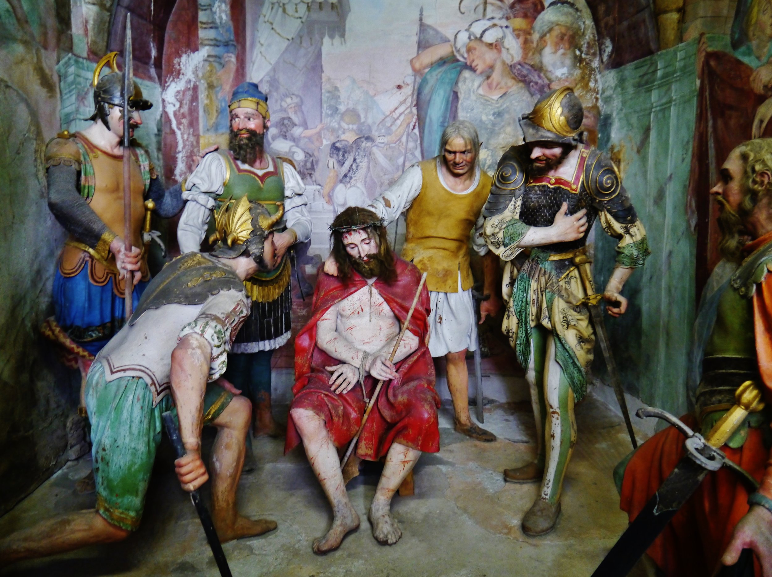 Painted statues of Christ and soldiers in Chapel 31 at the Sacro Monte of Varallo.