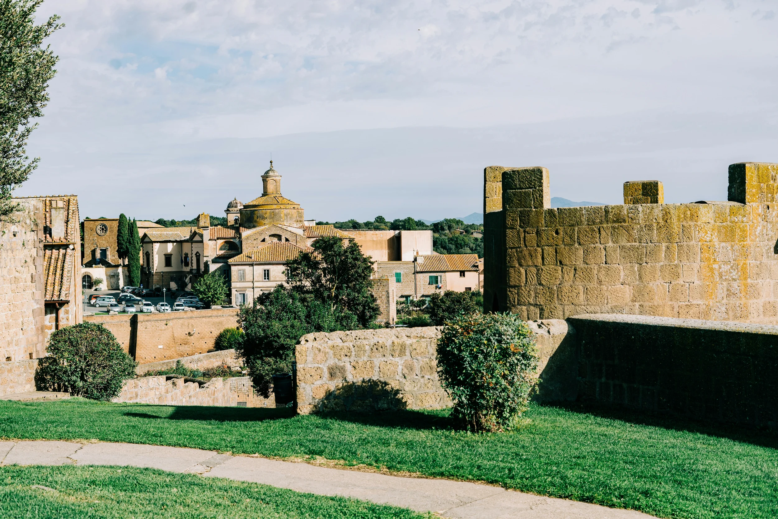 Historic fortified town in Lazio with medieval stone walls, church domes and Mediterranean landscape