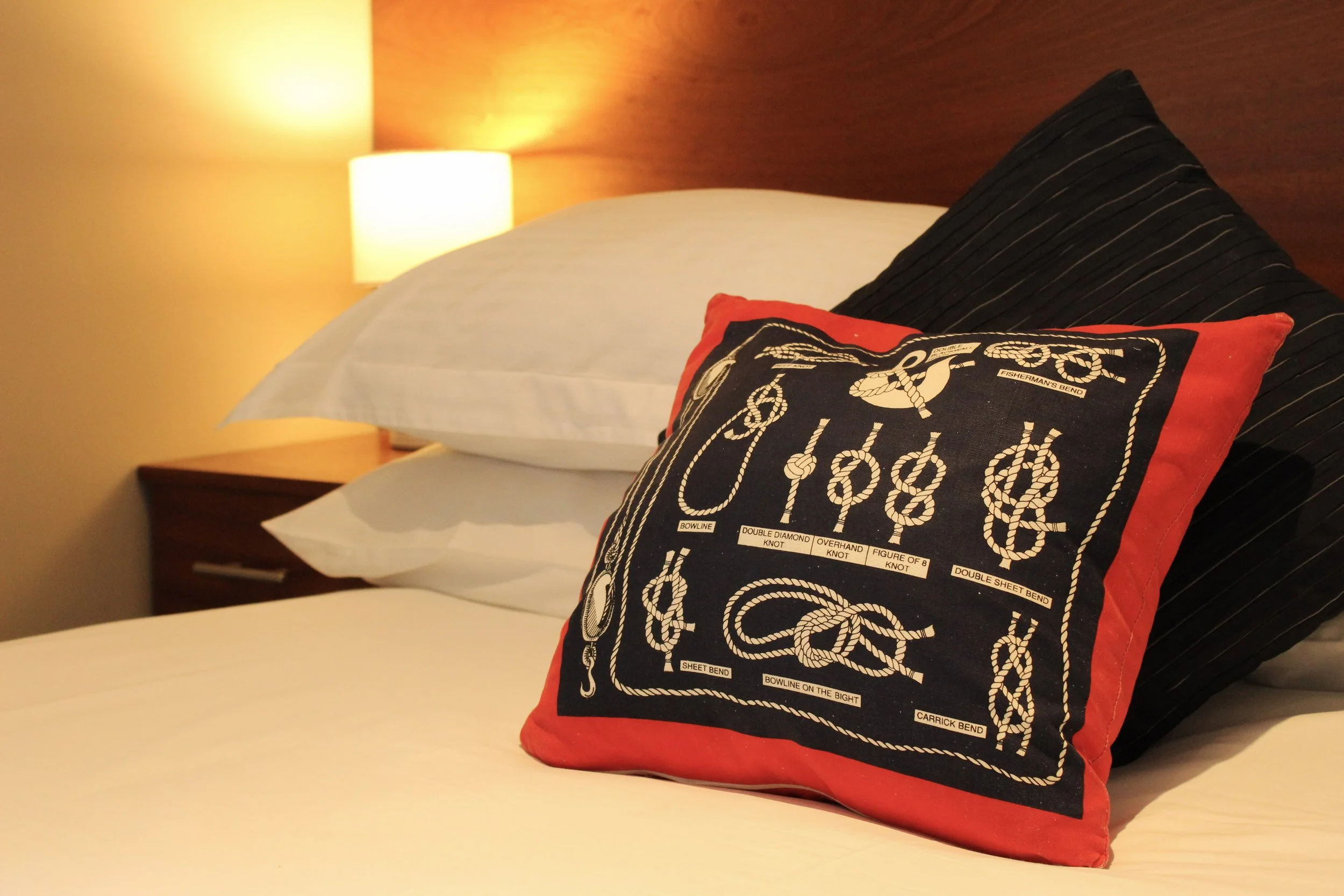 Close up of pillow on bedding showing nautical themed bedding