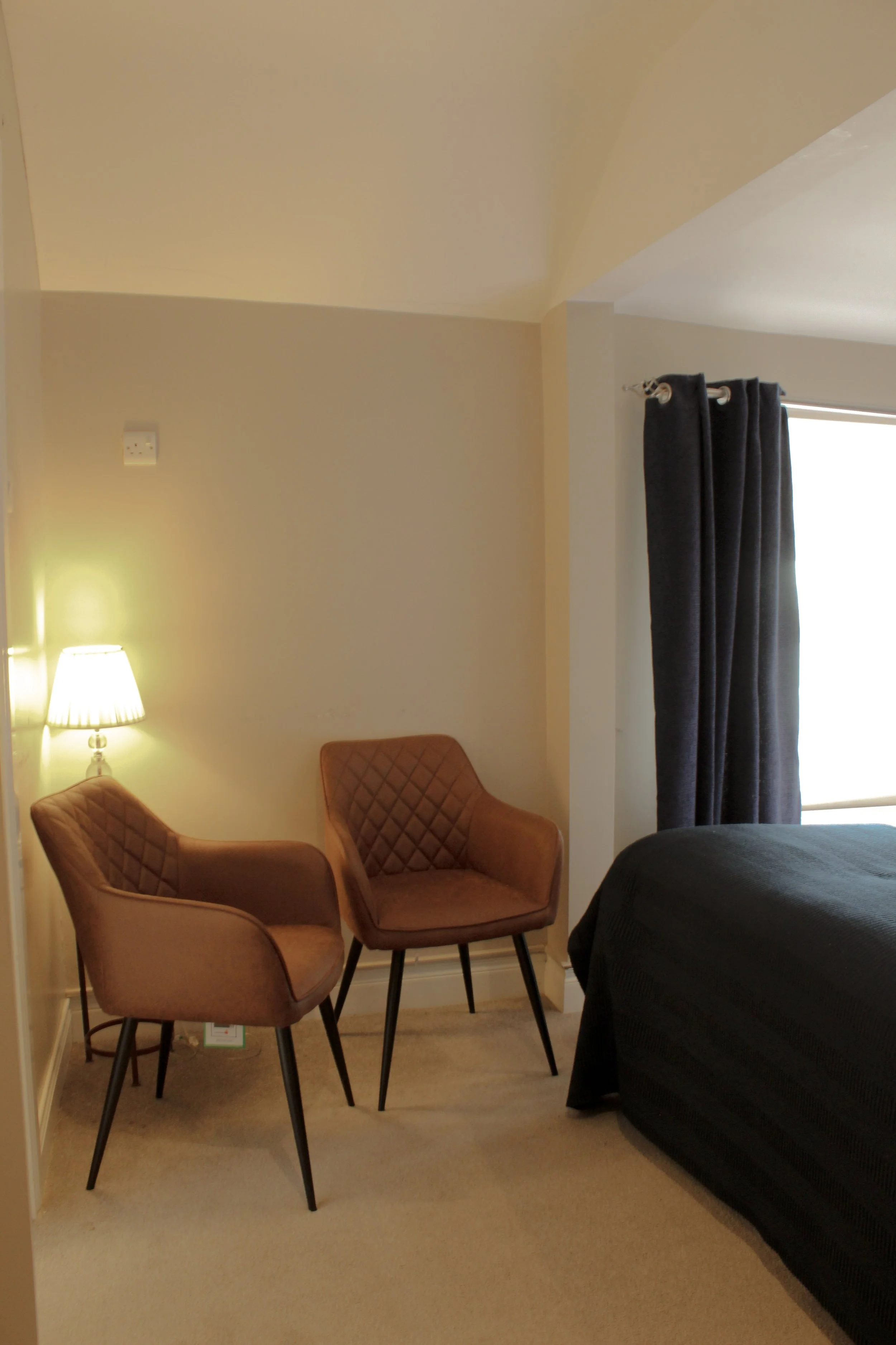 Two chairs in one of the larger rooms at the Pier 36 guest house