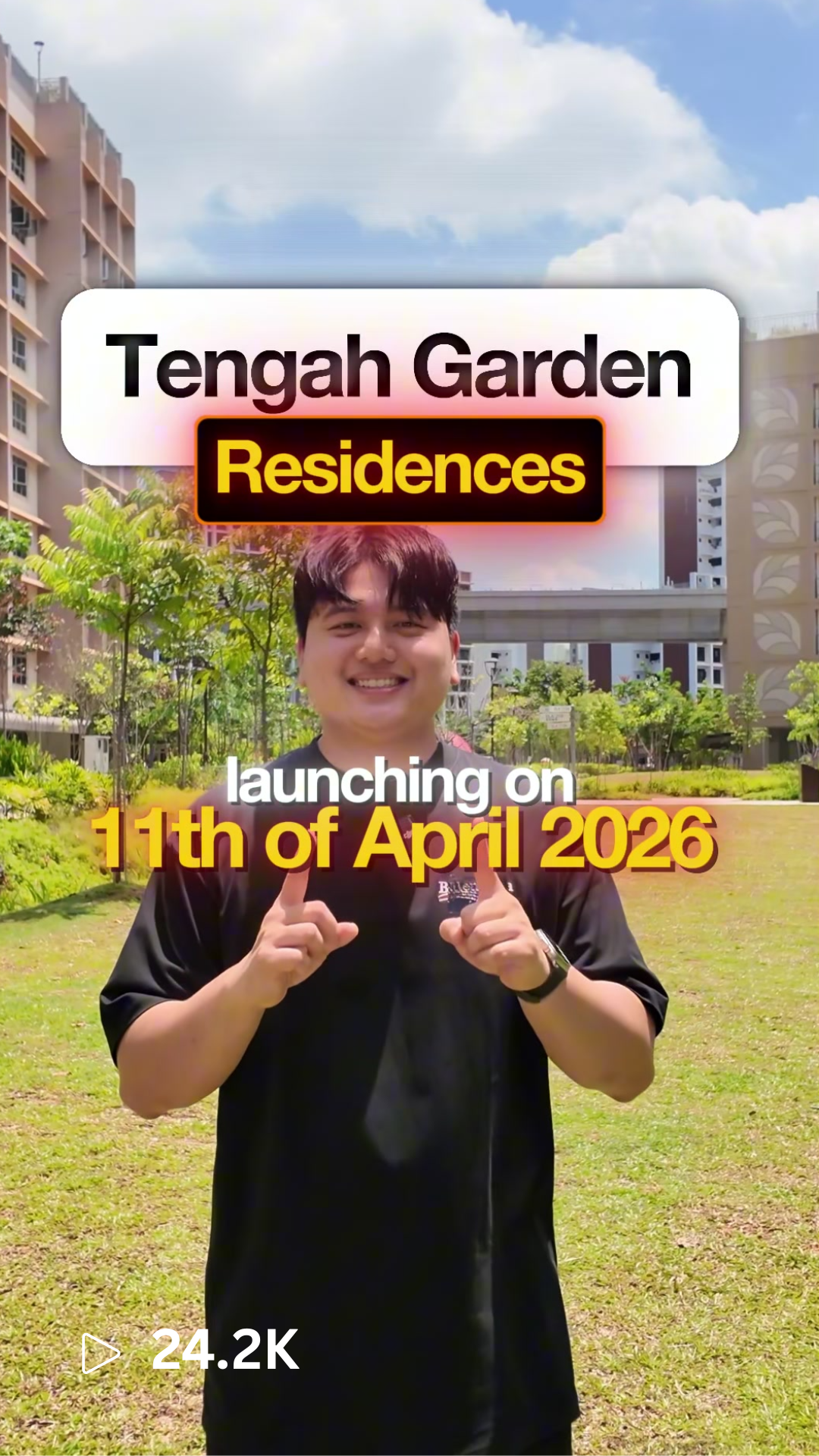 Young man smiling and pointing at the camera, standing in a garden with tall residential buildings in the background, announcing the launch of Tengah Garden Residences on April 11, 2026.