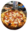 A pizza with cheese and pepperoni on a plate.