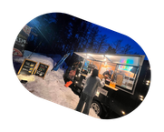 Food truck serving customers in snowy outdoor setting at night