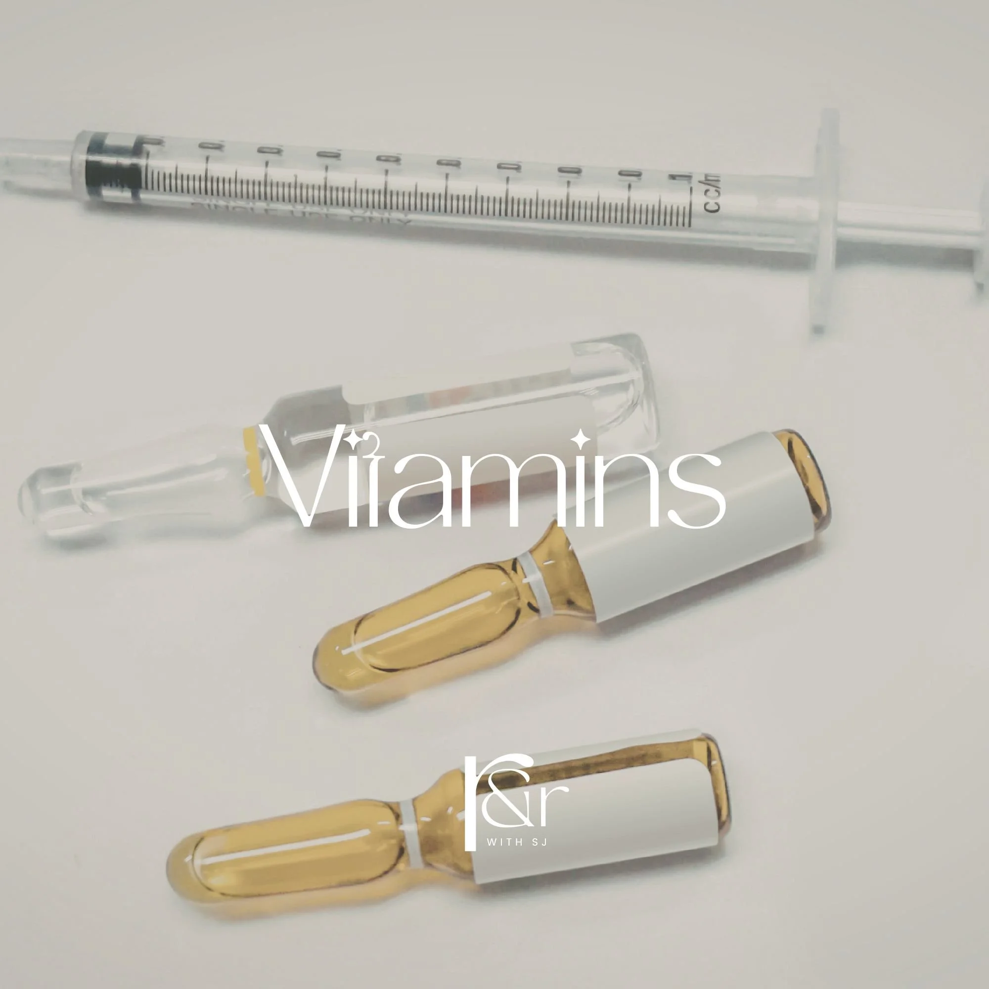 Vitamins shown with a syringe, two ampoules filled with liquid, and a dropper, all set against a white background.