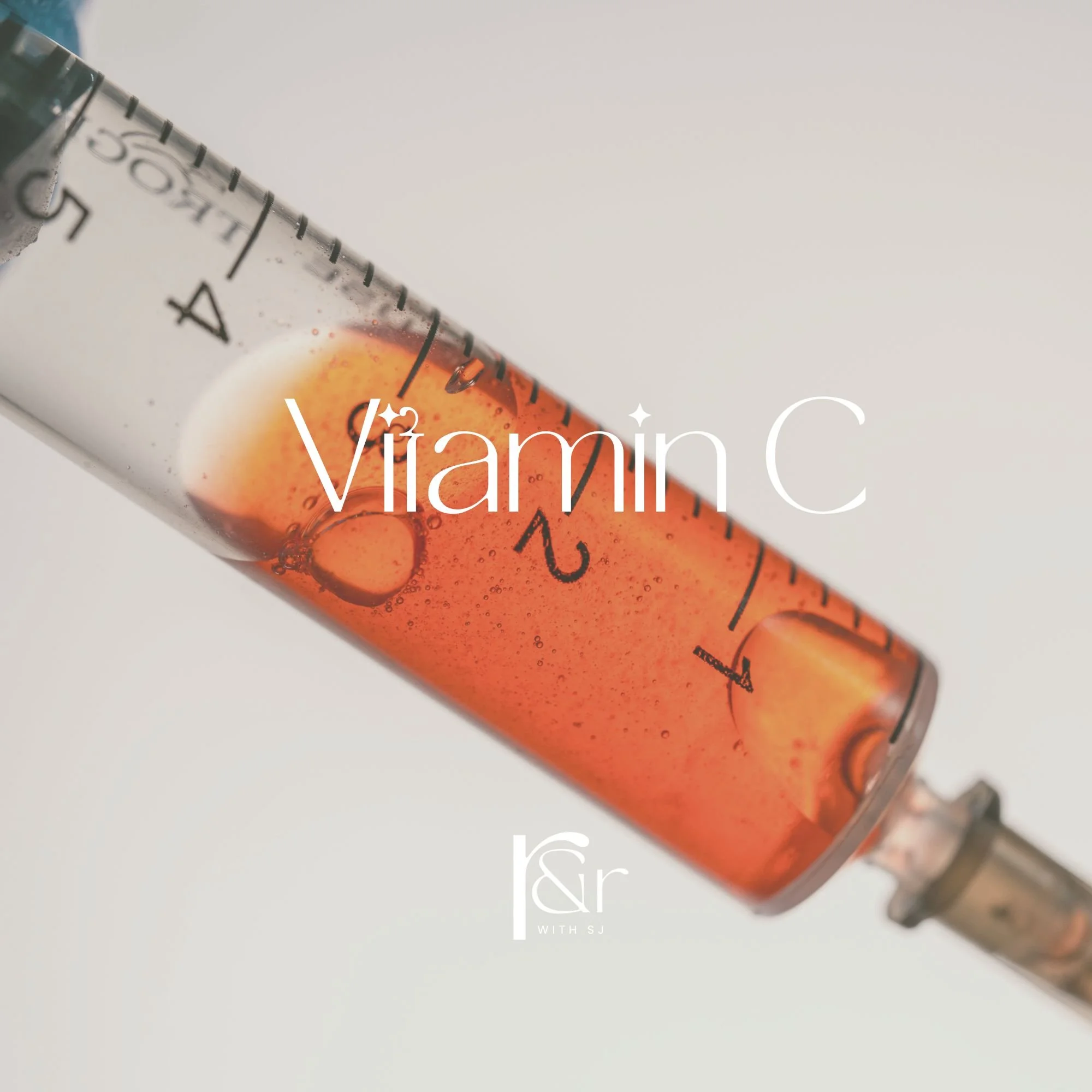 Close-up of a syringe filled with an orange liquid, labeled with measurement marks, and the text 'Vitamin C' overlaying the image.