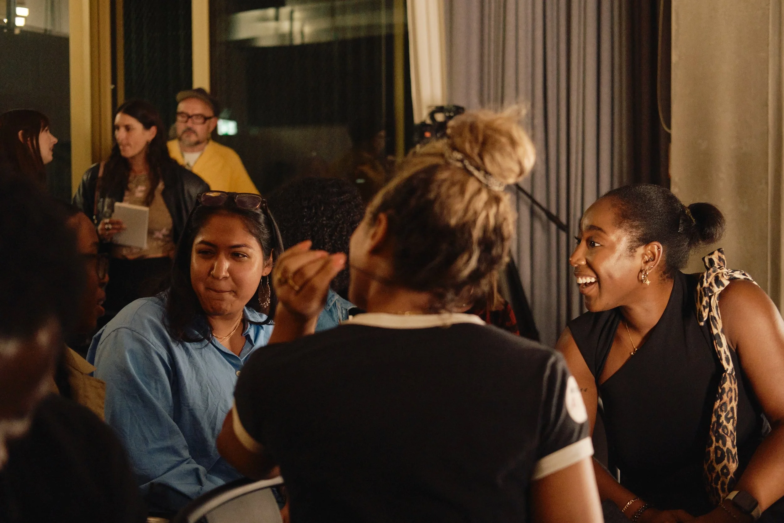 people socializing in a room for a networking event hosted by loose.fm