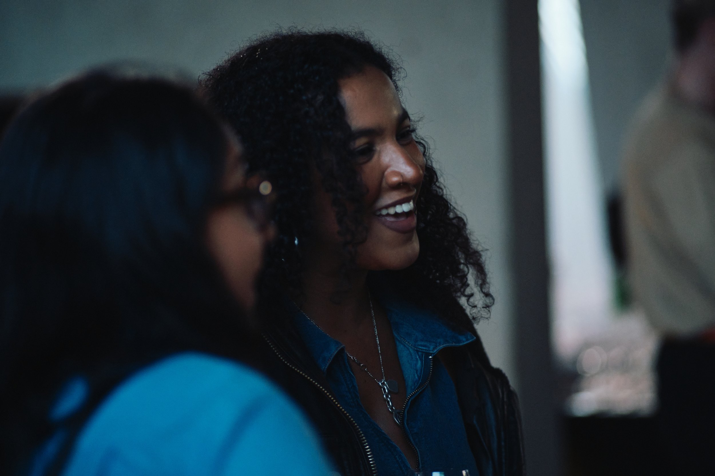 a girl laughing and socializing at a networking event