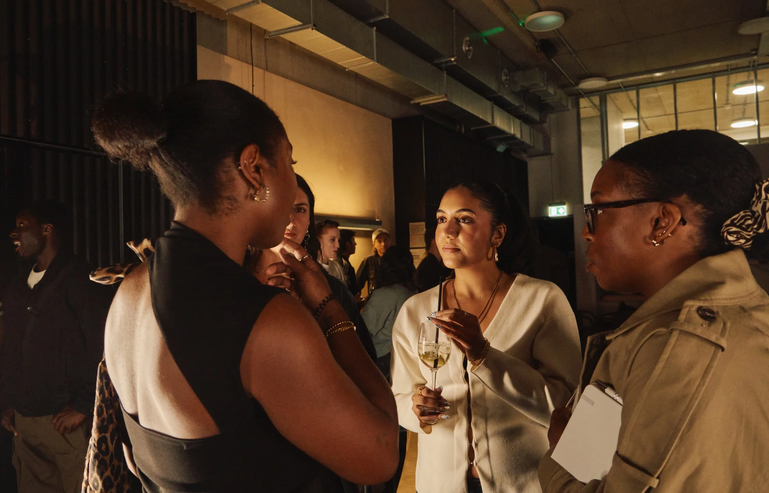 four girls socializing in a room for a networking event