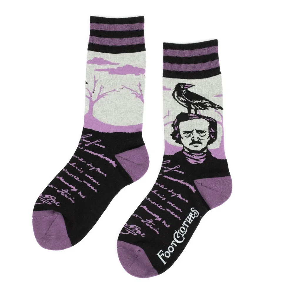 Pair of socks featuring Edgar Allan Poe with a raven on his shoulder, a tree and clouds, and handwritten text, with purple, black, and gray colors.