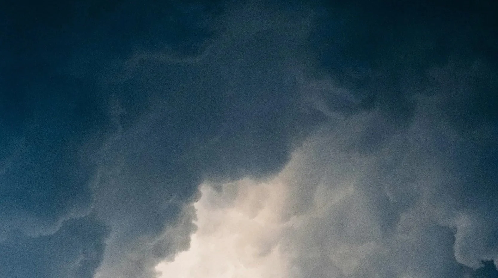 Dark storm clouds in the sky with some light breaking through.