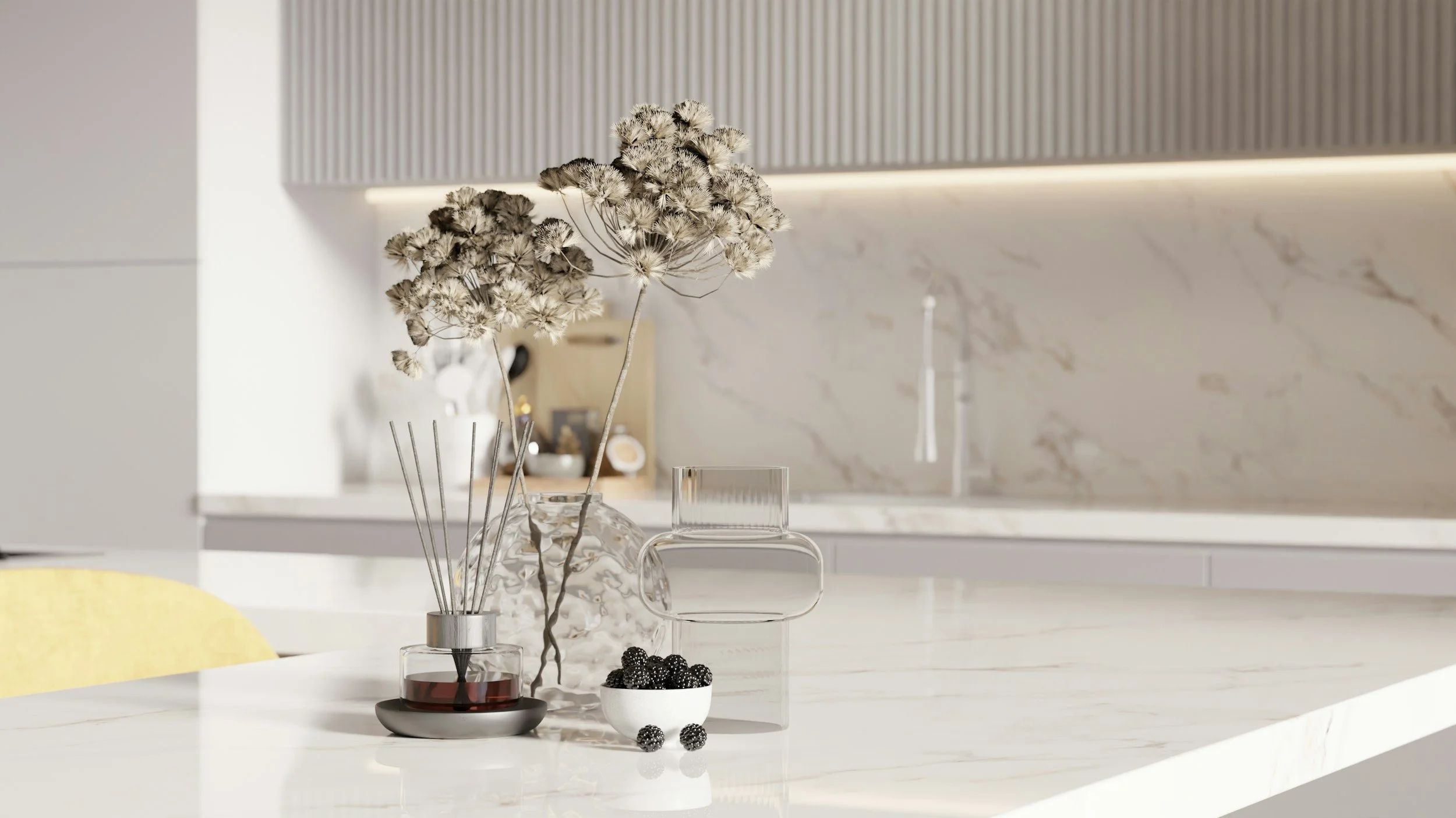 Close-up view of a modern kitchen with a white marble countertop, a glass vase with dried flowers, a small bowl of blackberries, and a glass of red wine, with a marble backsplash and minimalist decor.