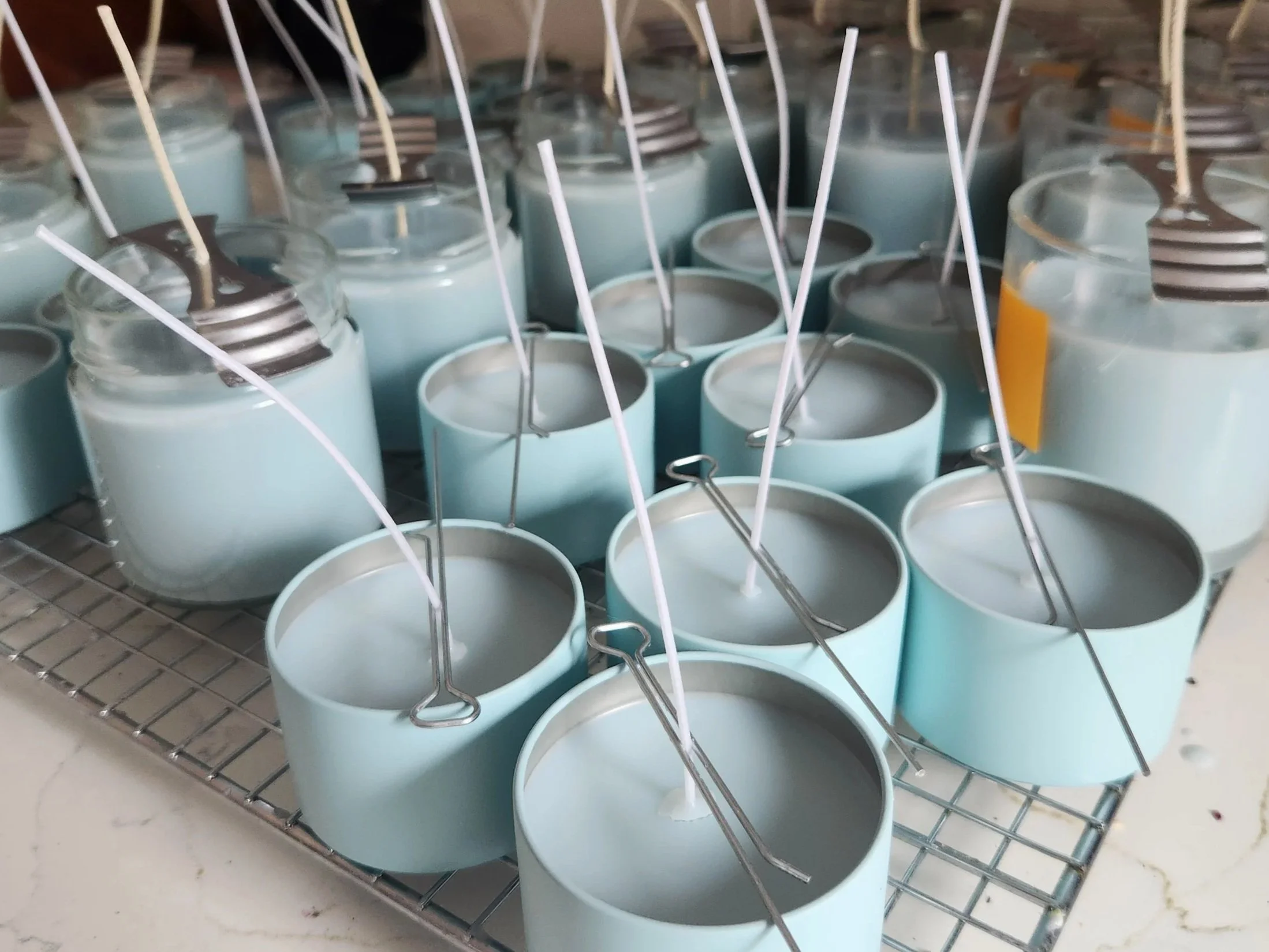 Oceans Tide behind the scenes production, all candle size curing on a rack