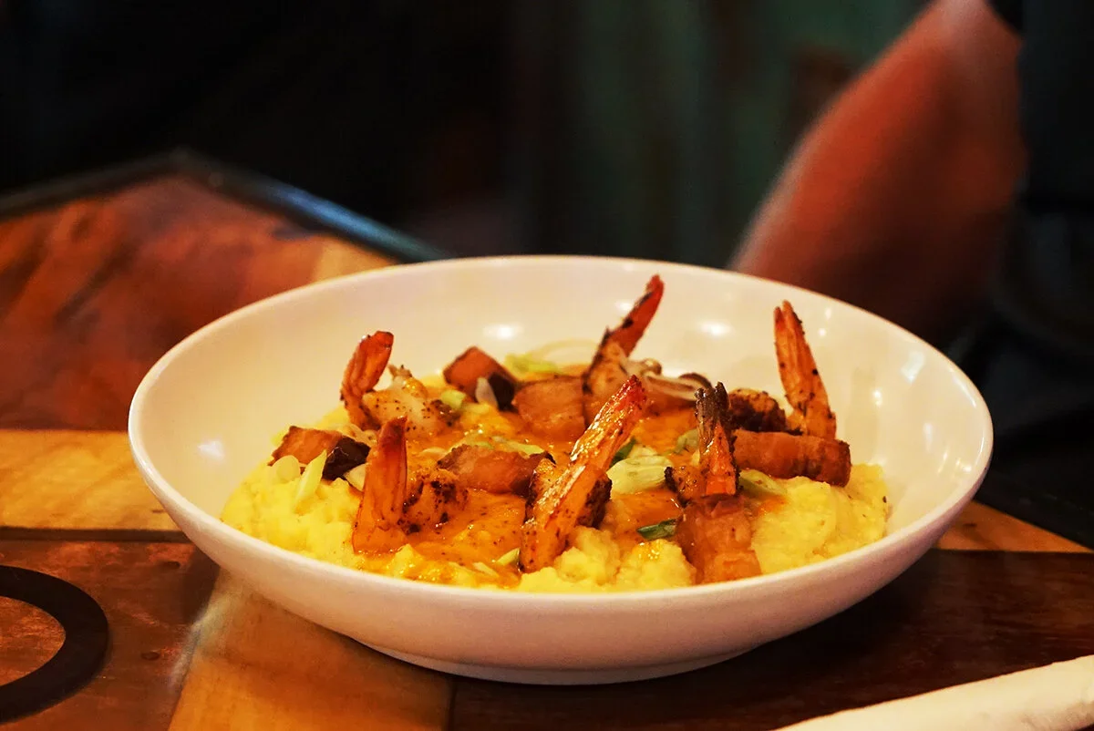 Authentic Low Country plates- shrimp and grits, beer-battered cod, and slow-roasted Carolina BBQ..webp