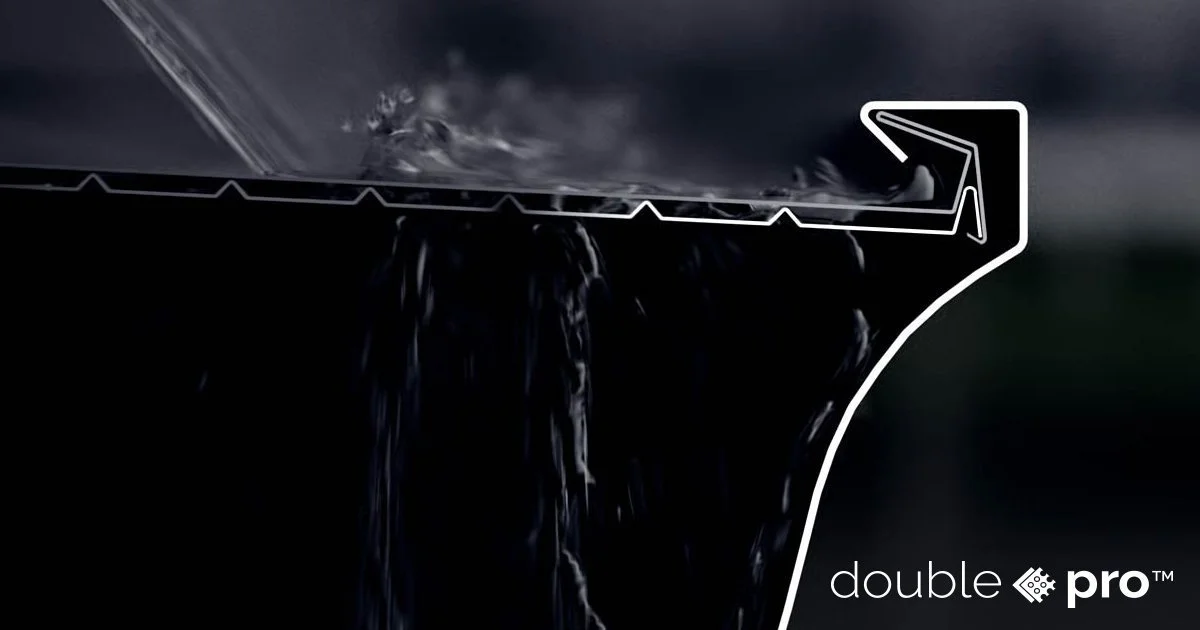 Close-up of a cross-section of a cookware pan with the water drainage system highlighted by a white outline and arrow, showing how water drains from the pan. Branding at the bottom right reads "double pro."