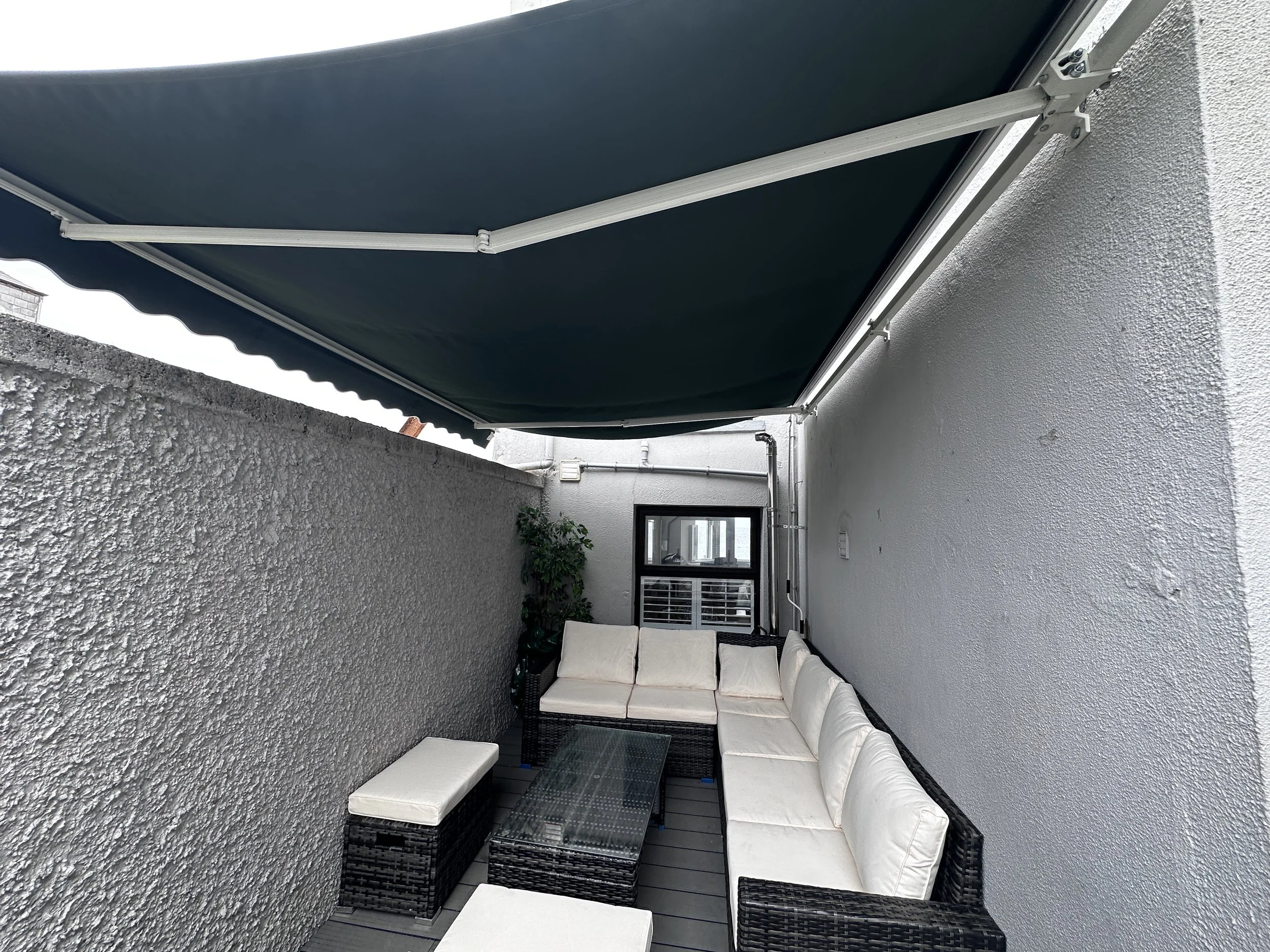 Sun/Rain shade for deck. On a warm summer's day it can drizzle a little so perfect for relaxing outdoors in the dry.