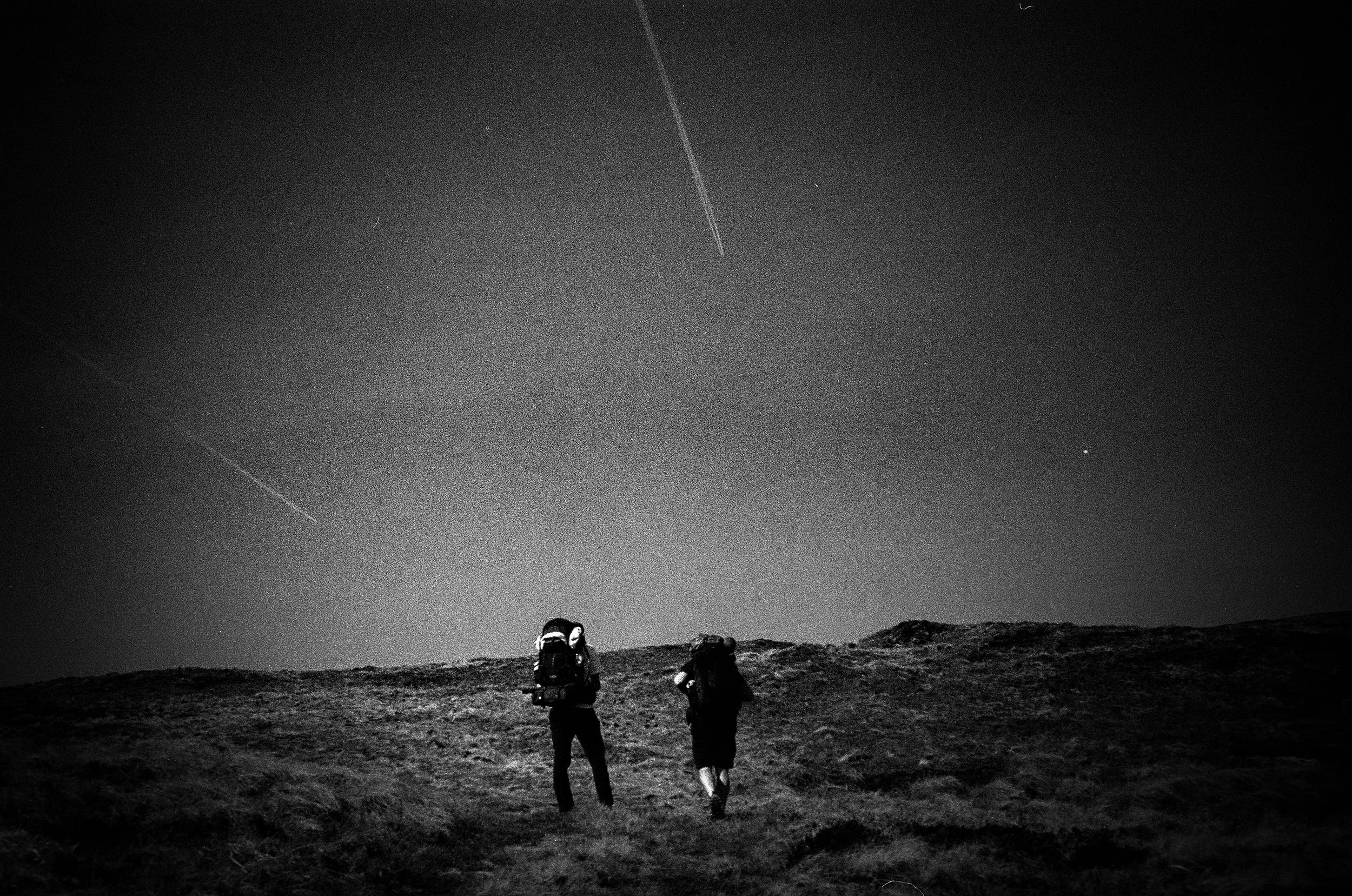 Two backpackers under contrails.jpg