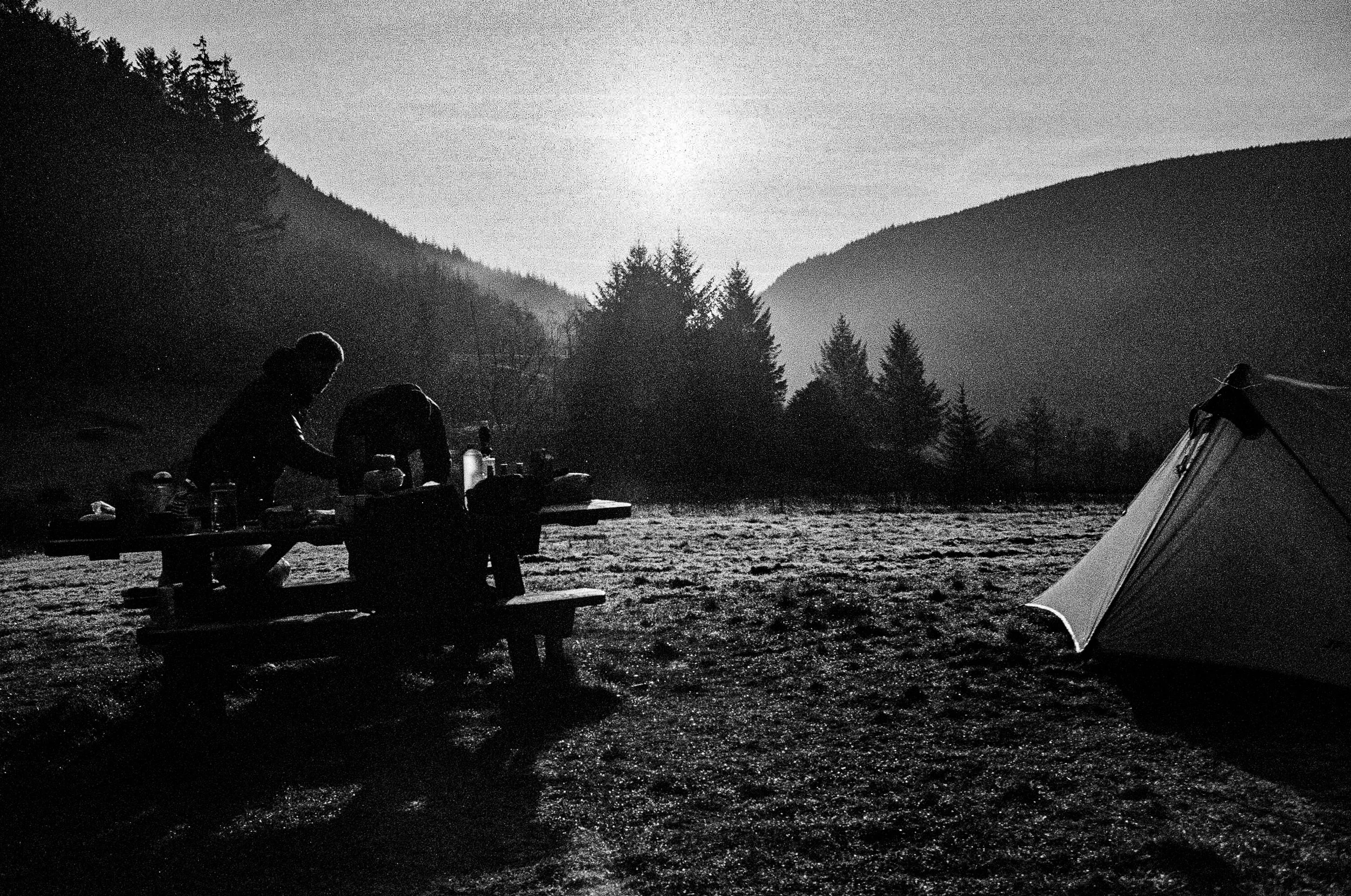 Campsite morning, silhouetted figures, tent, mist.jpg