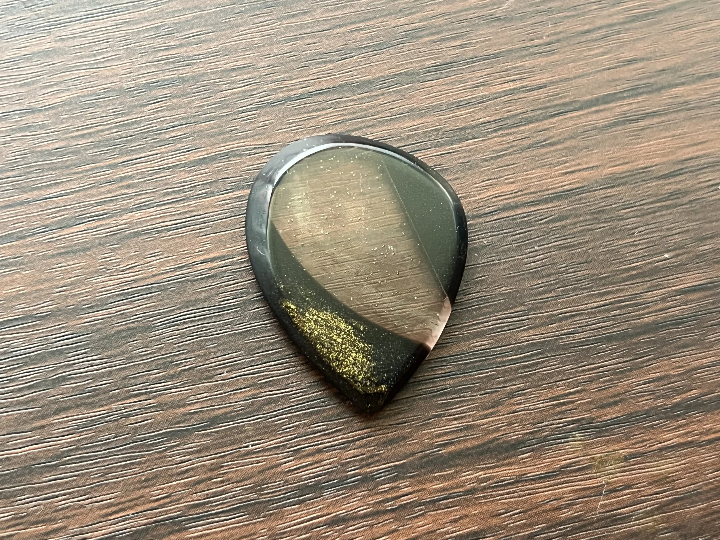 A glass orb on a wooden surface reflecting light.