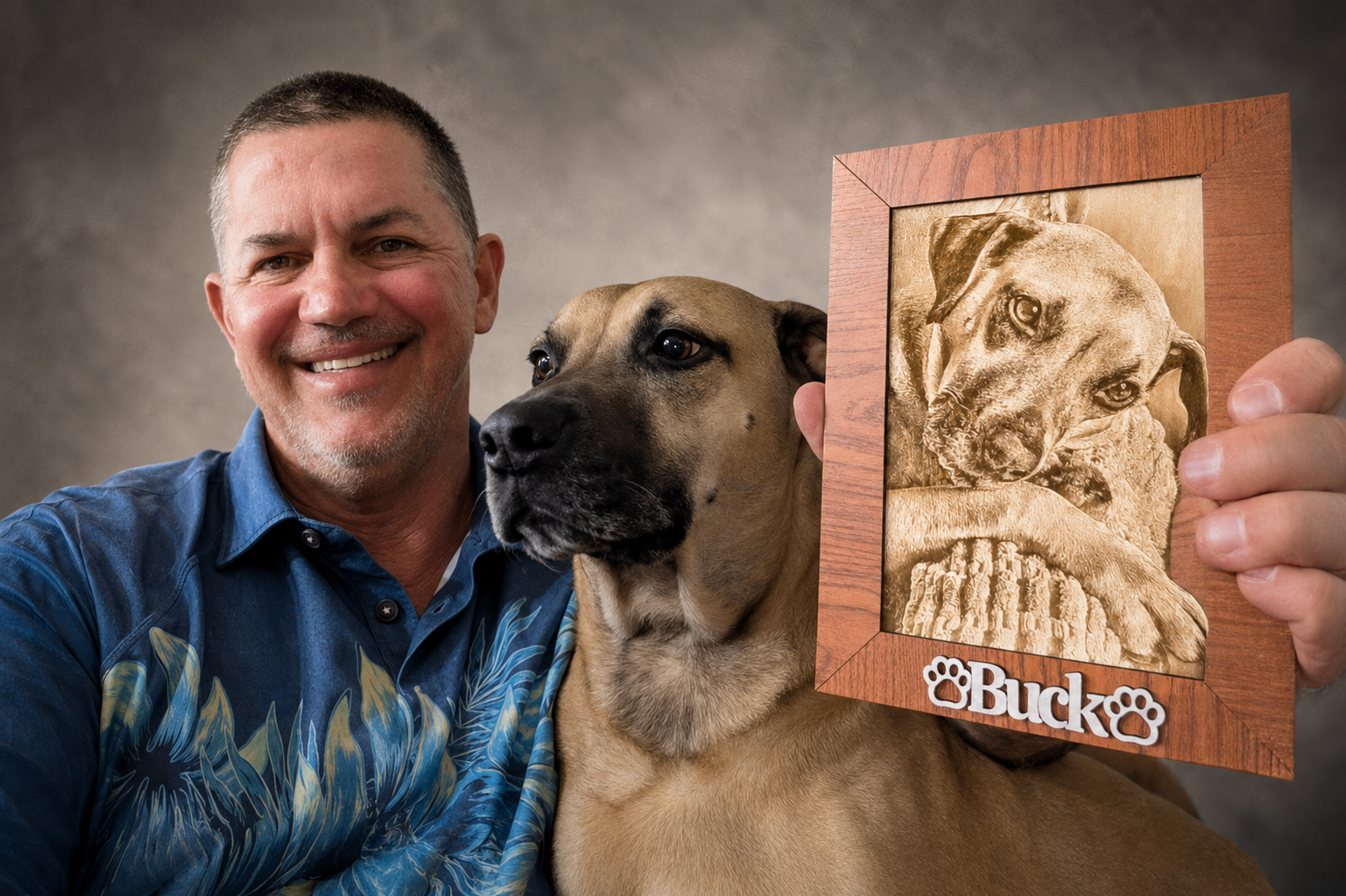 Man with his dog holding a handcrafted laser-engraved pet portrait in a walnut frame.
