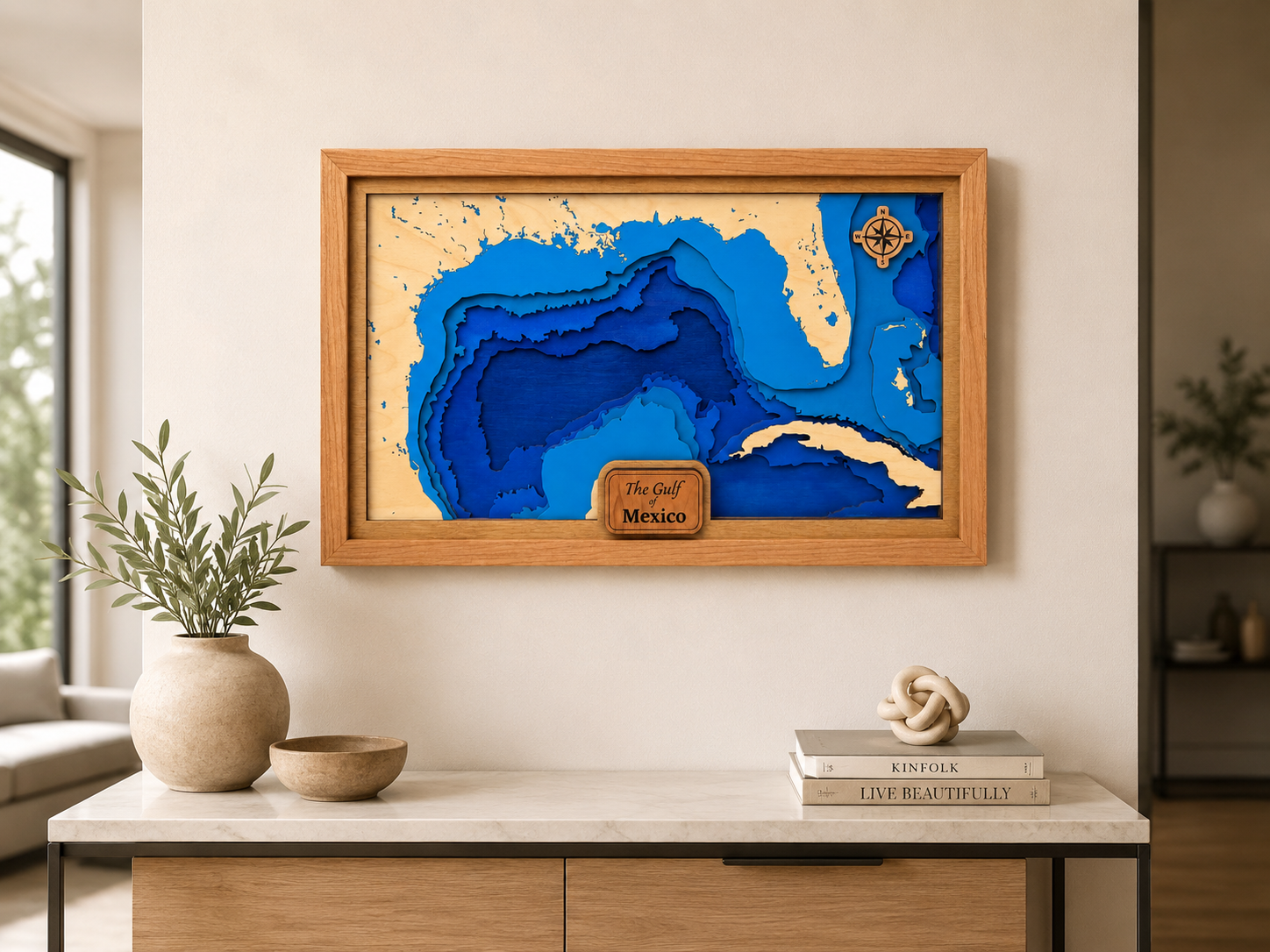 Framed layered wooden lake map displayed above a console table.