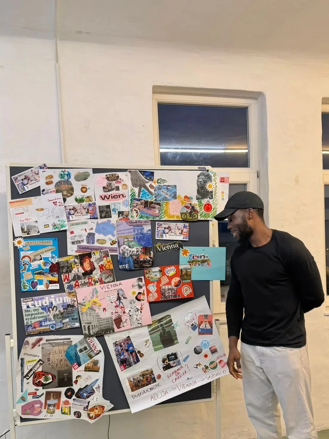 Participant presenting vision boards during the European Voices for Future (EVF) Vienna Mosaic event in Vienna, Austria — a creative community gathering focused on storytelling, belonging, diversity, and the future of the city.