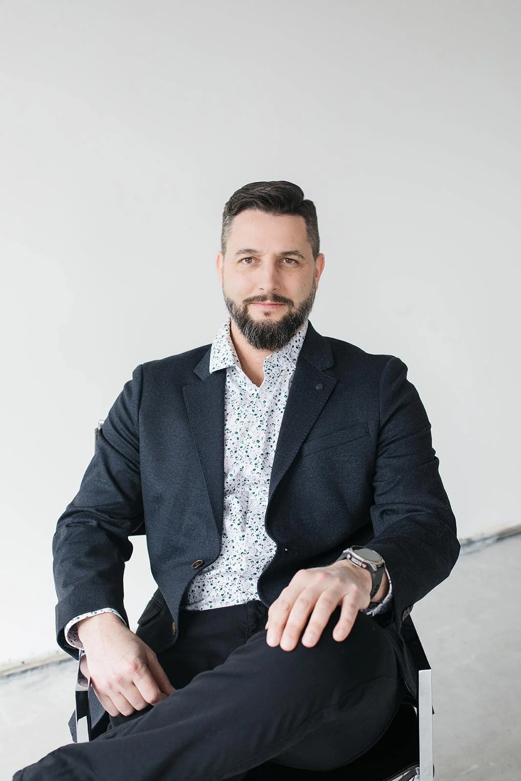 Brad Tymchyshyn, Vice President, Operations V2CM, standing in front of a wooden background.