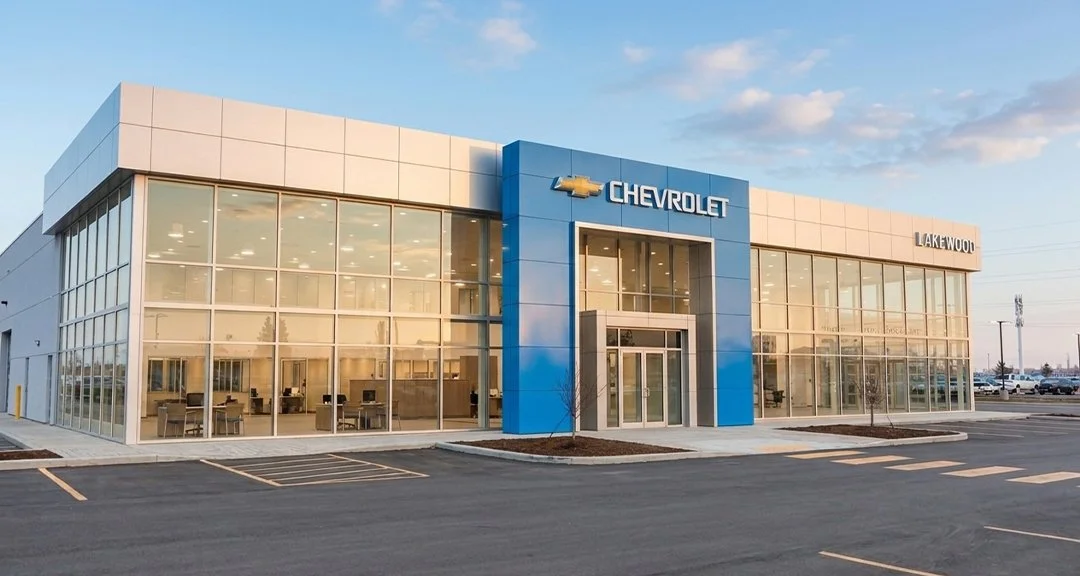 Exterior view of Chevrolet car dealership with large glass windows and blue signage, located in Lakewood.