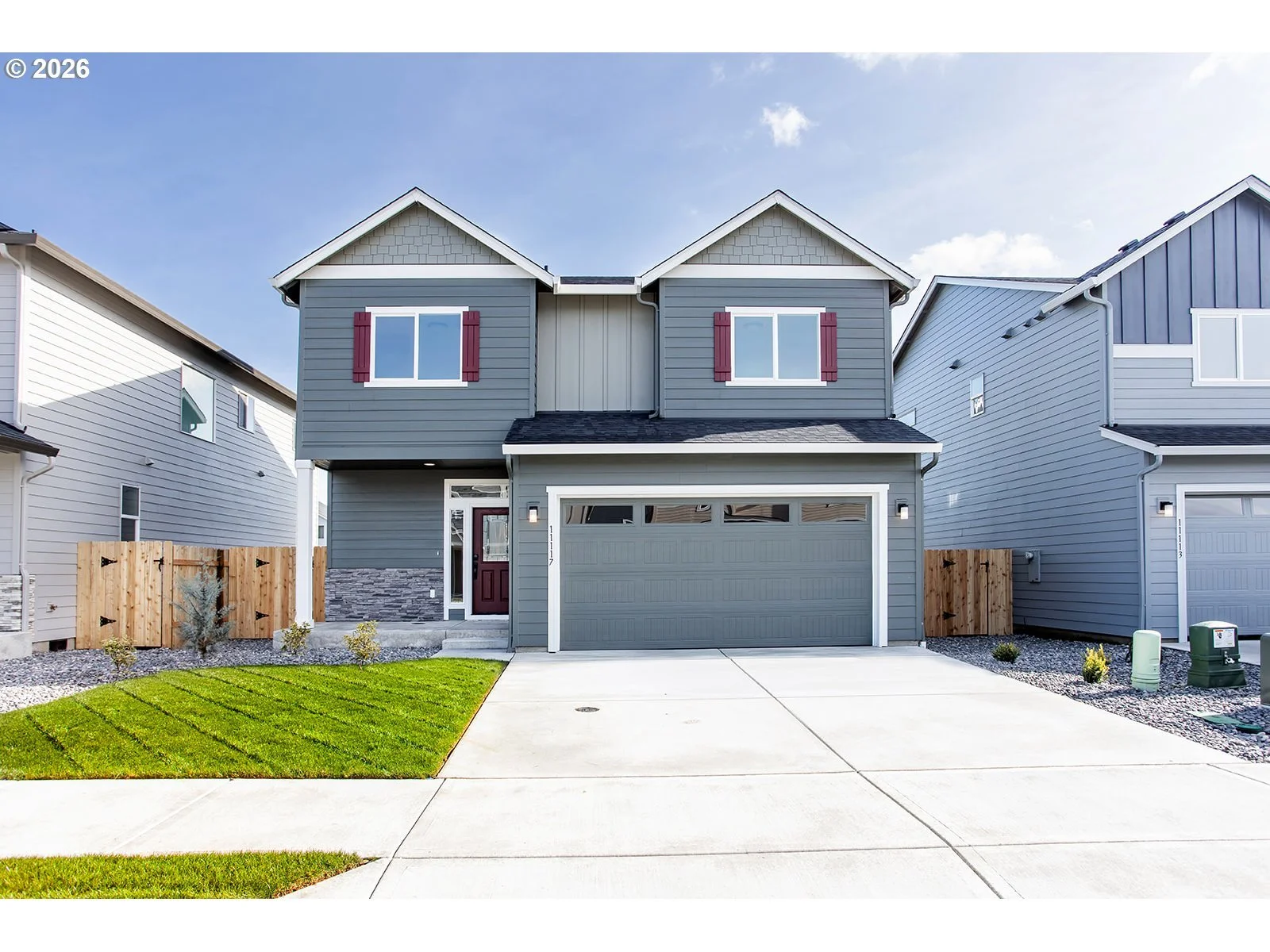 Photo of a two story home with a patch of grass on the left side