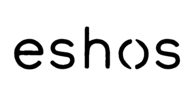 A group of dolphins jumping out of the water at sunset