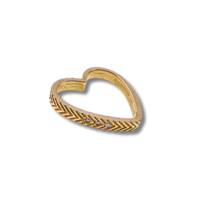 Gold heart-shaped ring with a decorative pattern along the band