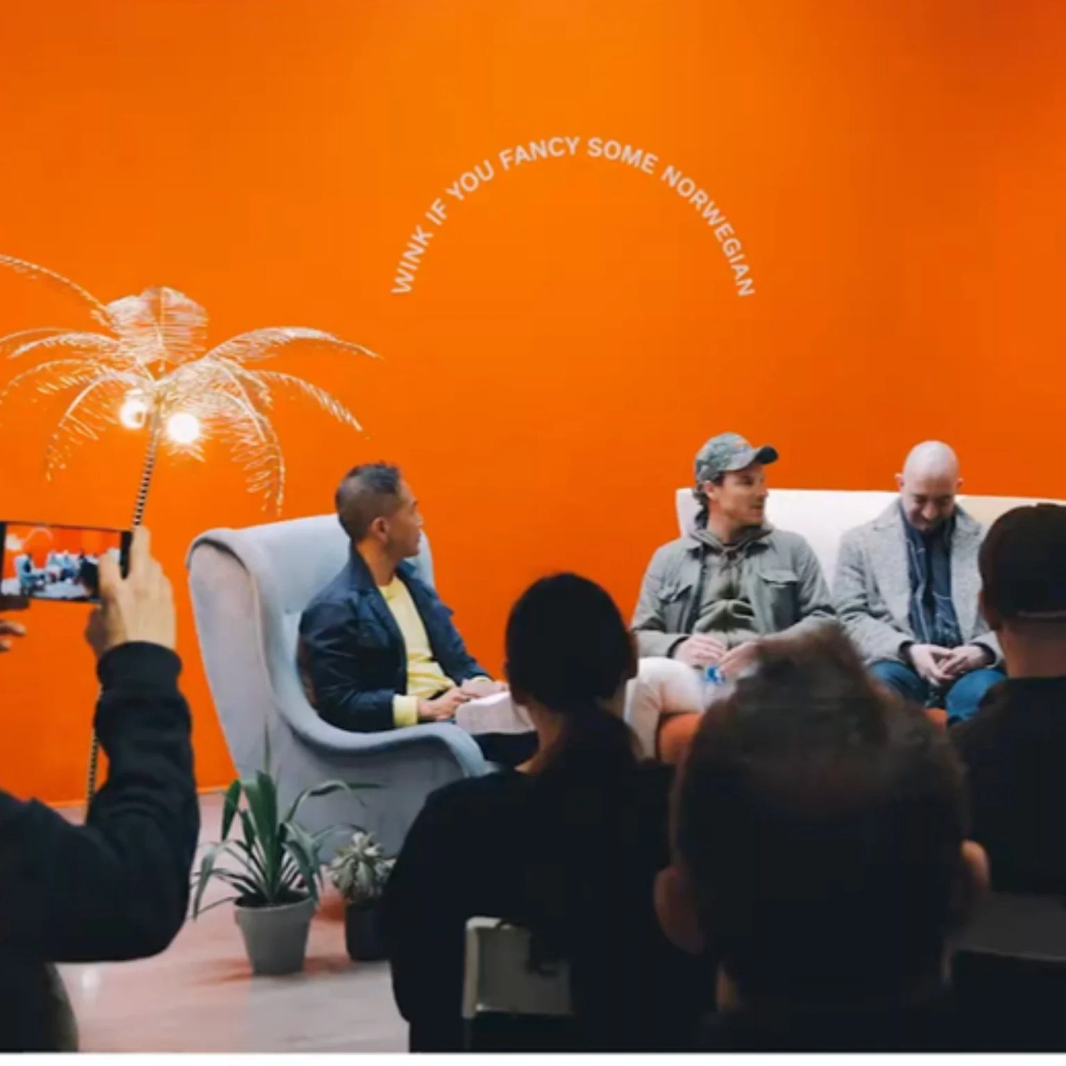 SWIMS NYC pop-up: a panel talk at the SoHo opening, in front of an orange wall