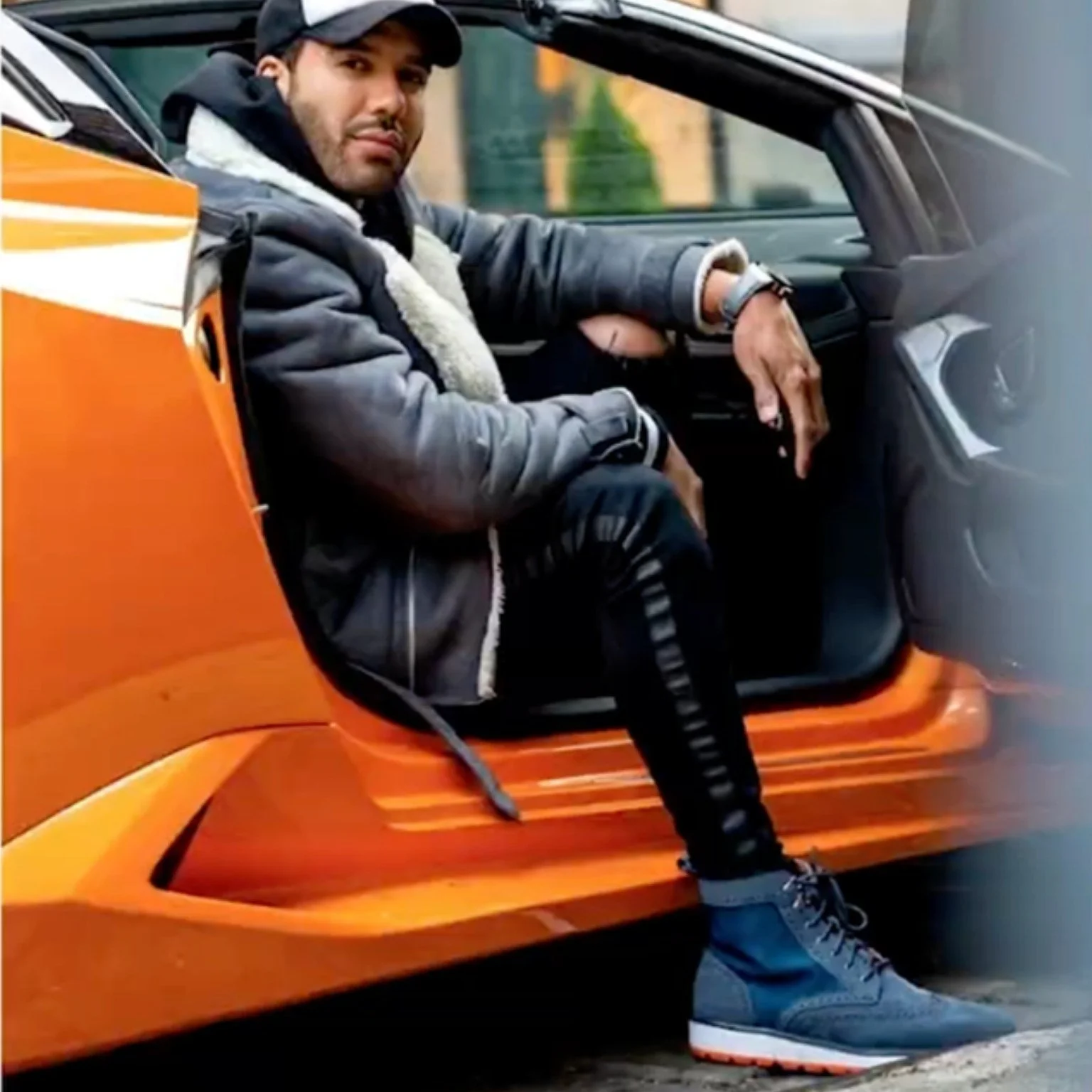 SWIMSpool campaign: a man in SWIMS boots stepping out of an orange supercar