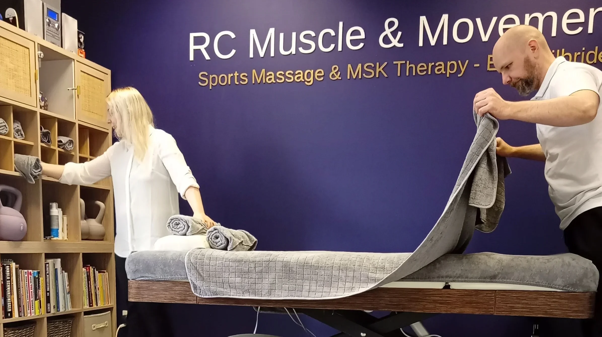 Ross and Paula preparing the treatment room at RC Muscle & Movement in East Kilbride.