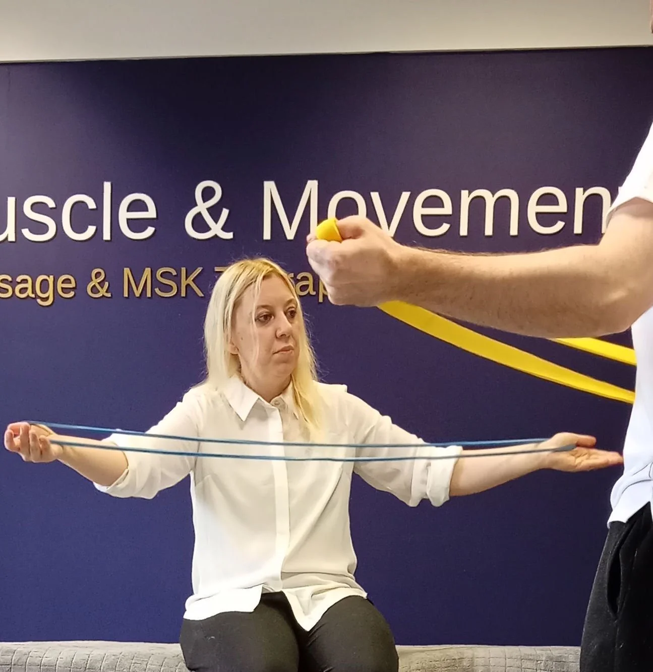 Ross and Paula demonstrating resistance-band movement in the RC Muscle & Movement clinic.