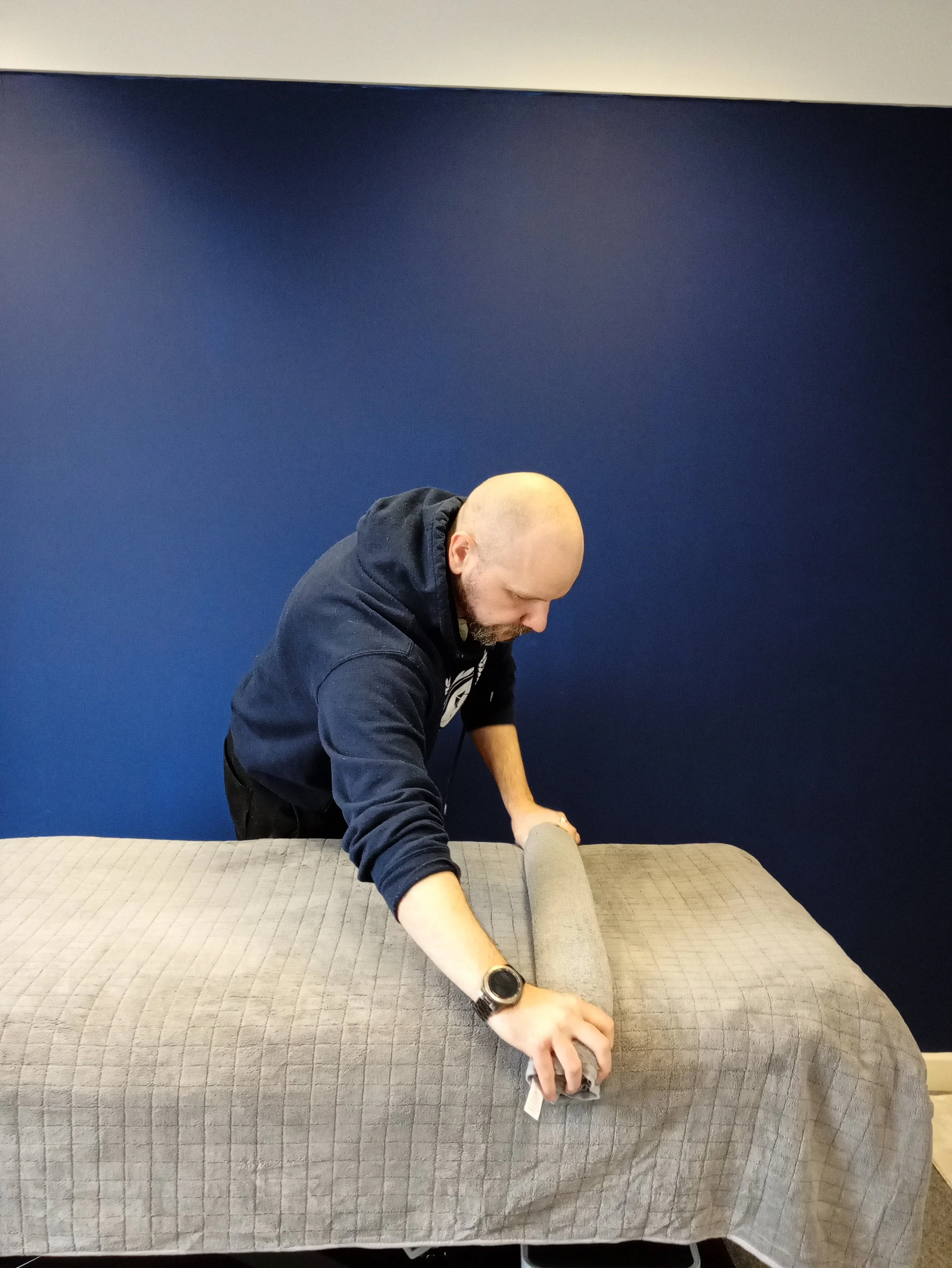 msk and sports therapist Ross setting up his treatment room for clients coming in