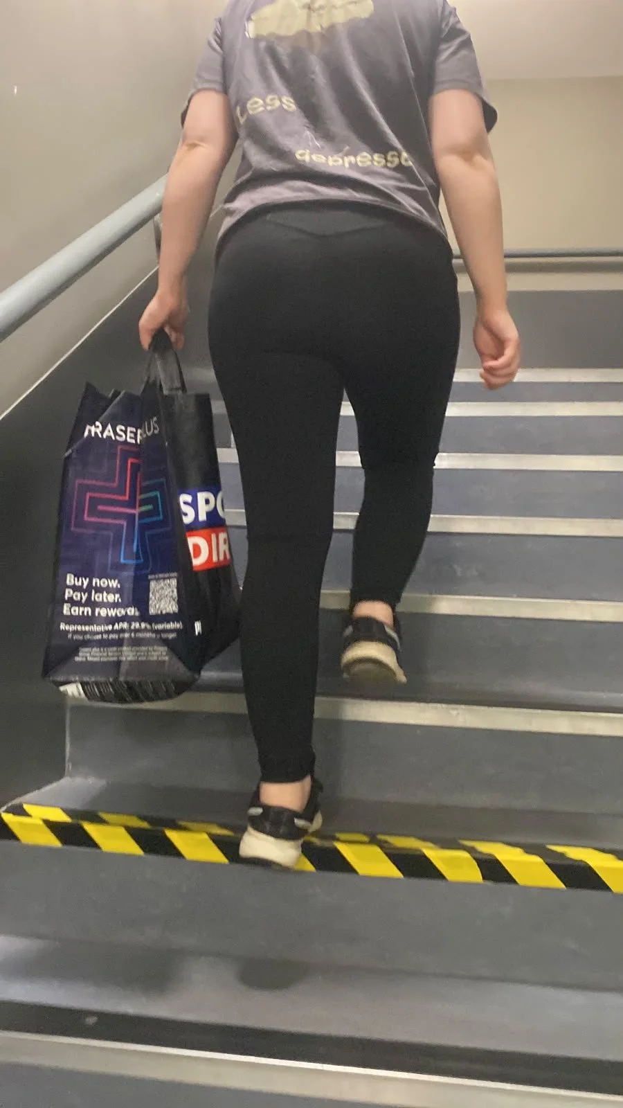 paula walking up stairs holding bag showing the daily demands we put on the body