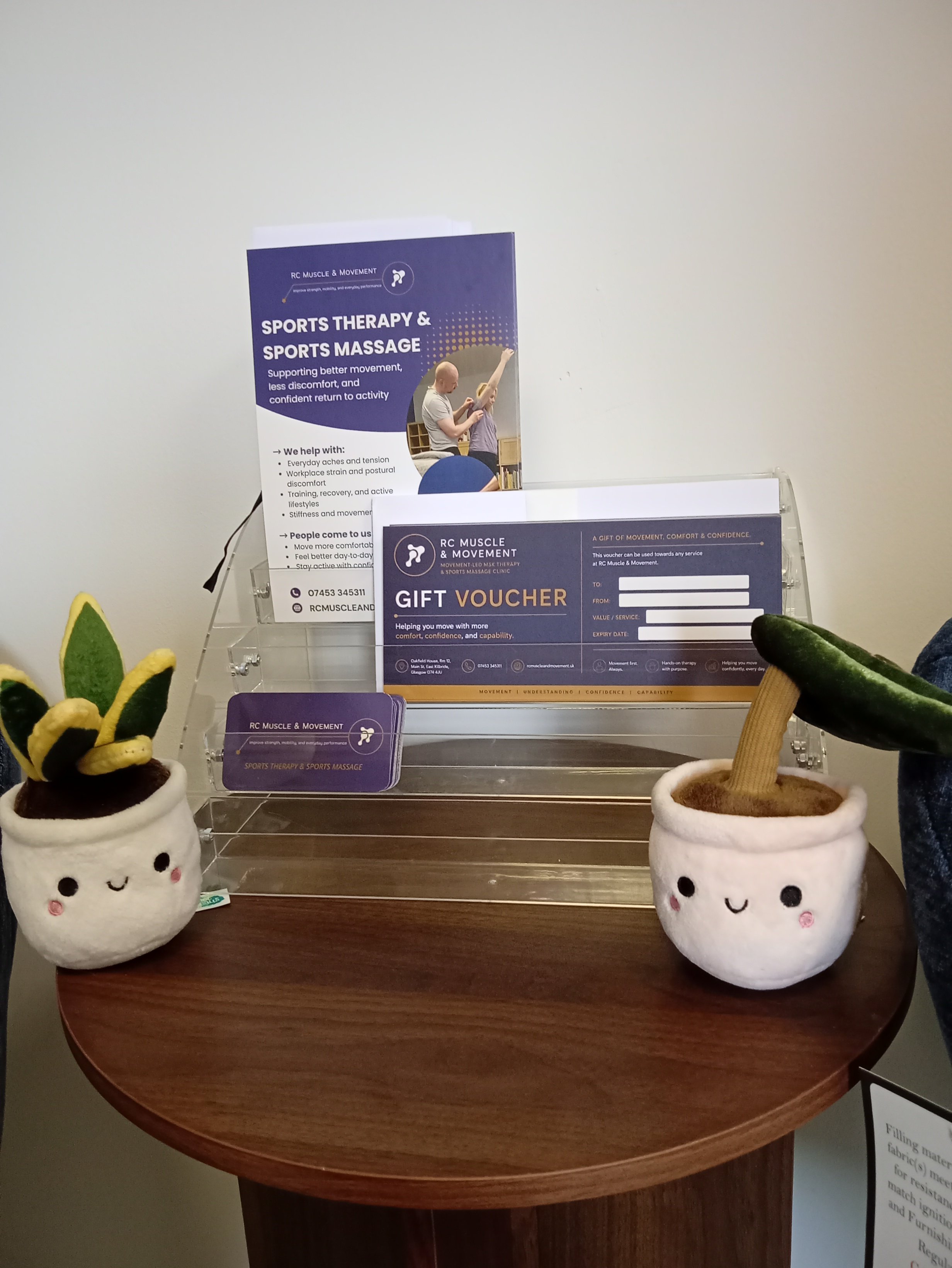 display table at rc muscle and movement clinic in east kilbride showing branded flyers , cards and vouchers