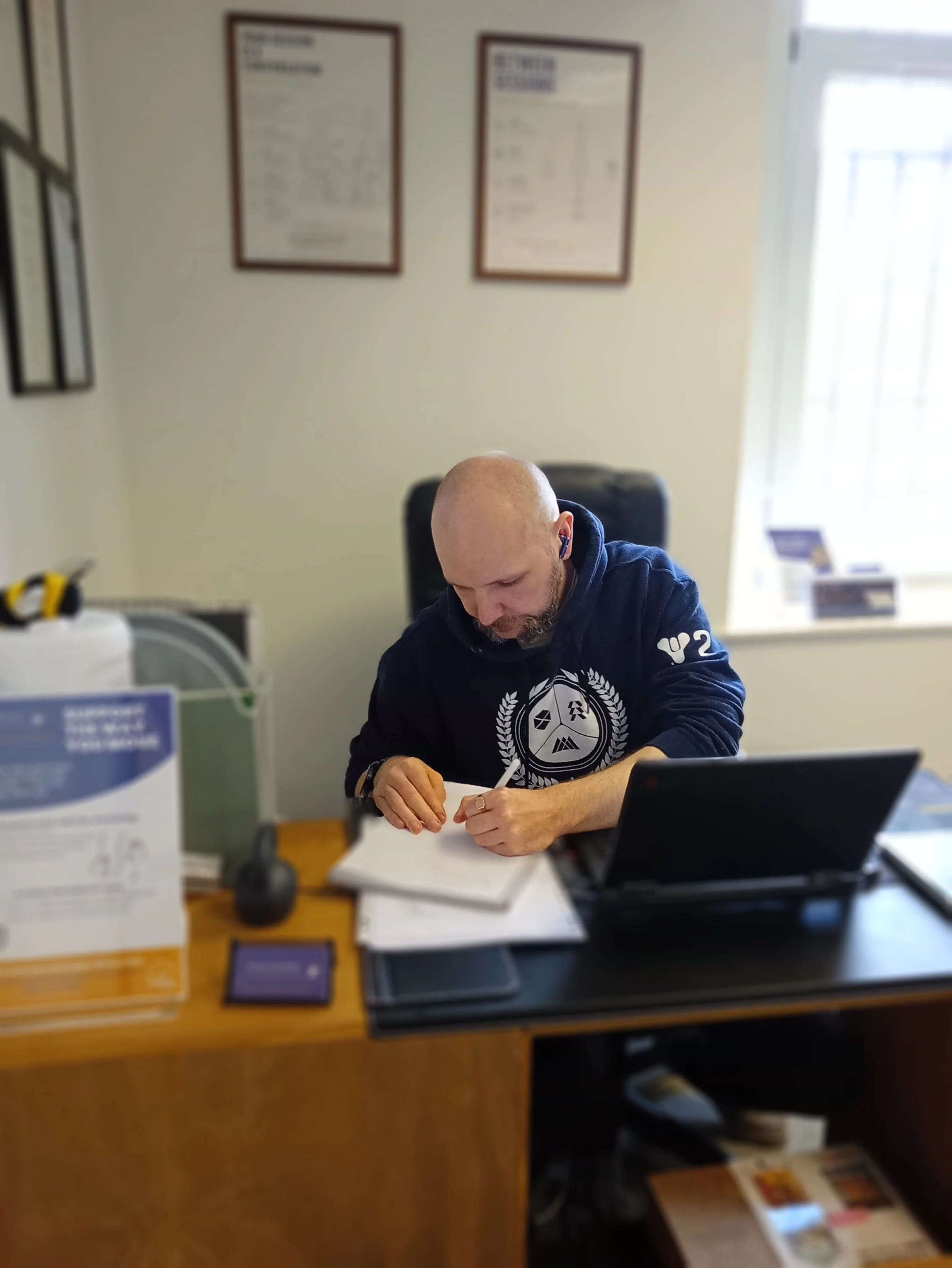 Ross Canning, Sports Therapist at RC Muscle & Movement, reviewing notes in the East Kilbride clinic.