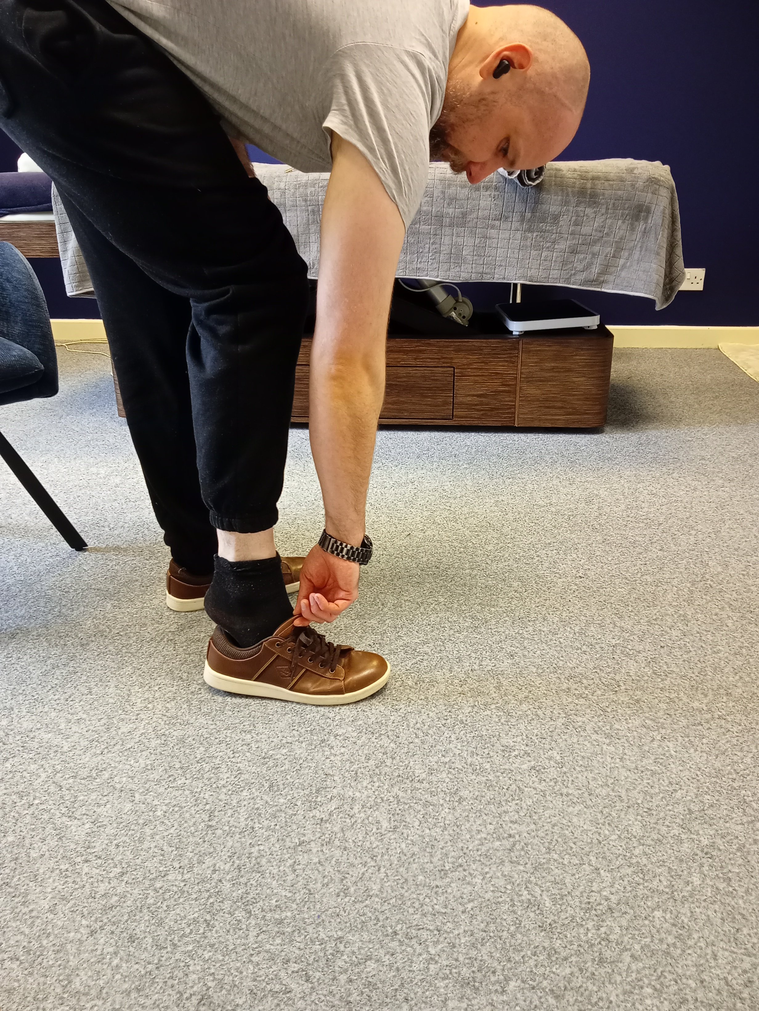 ross demonstrating that everyday movements like bending can cause back niggles