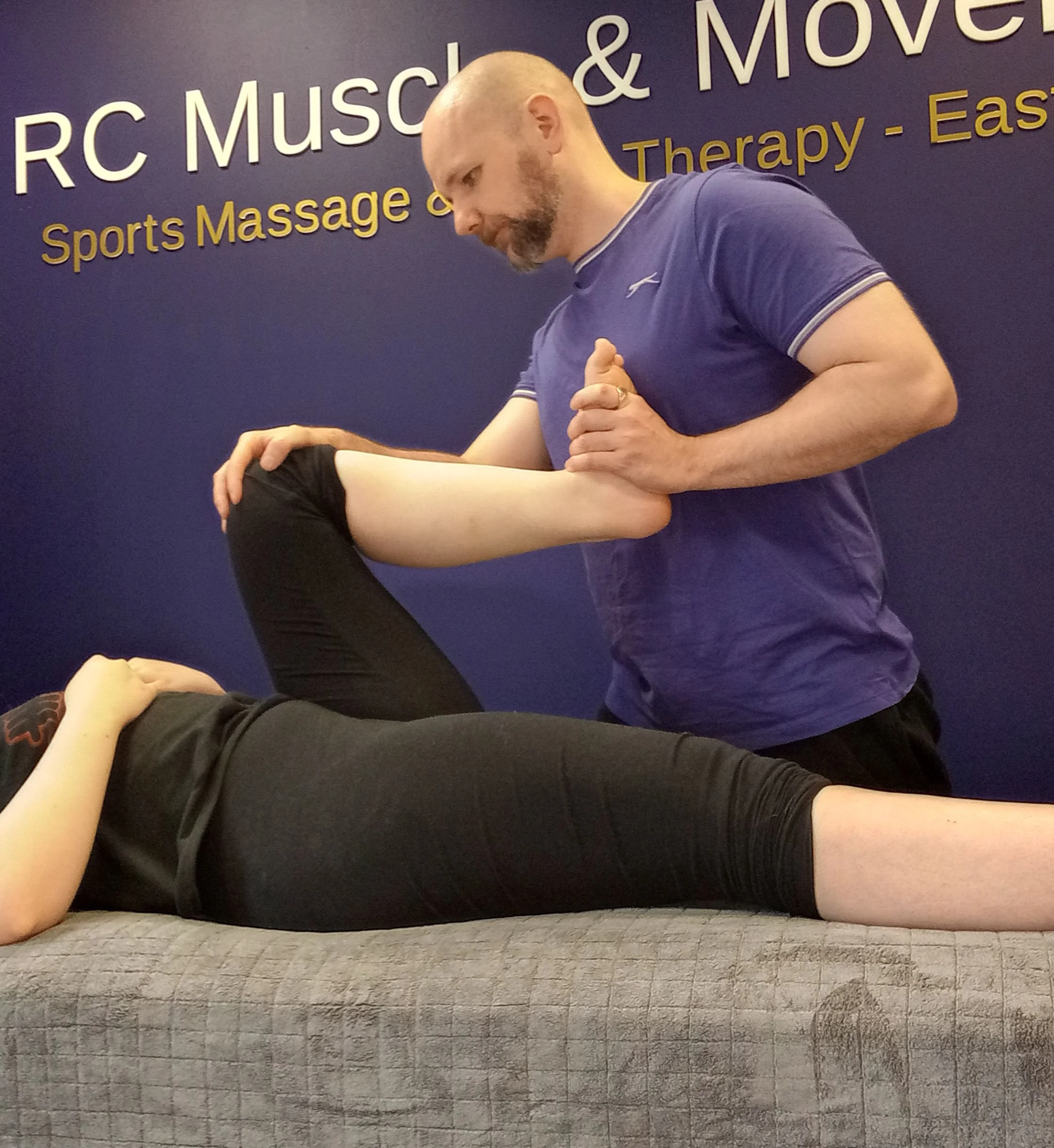 sports therapist checking hip mobility