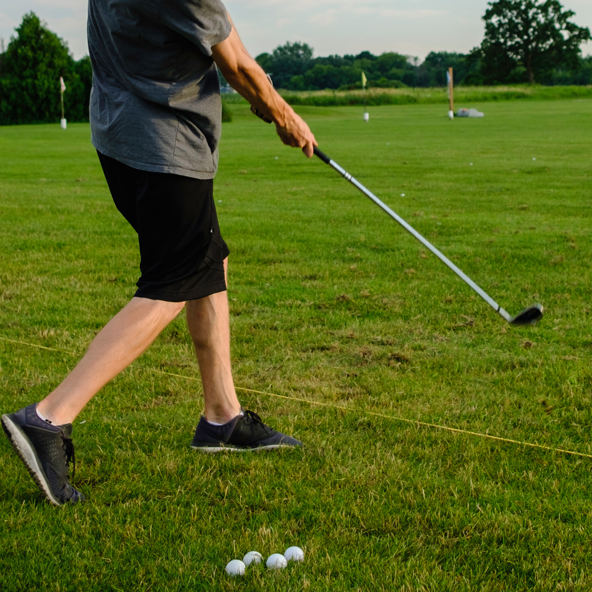 man pivoting to make a big golf swing